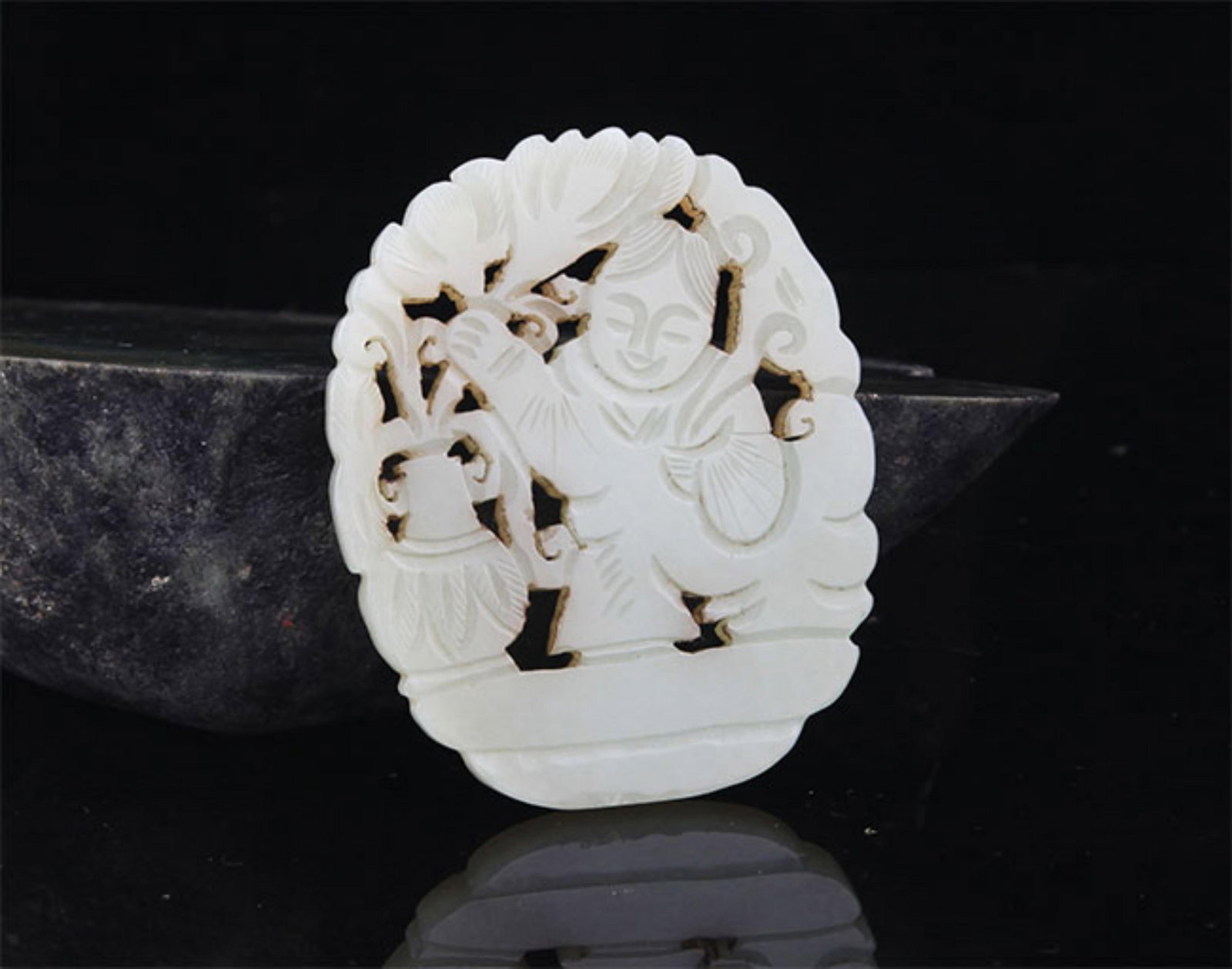 A FINE HE TIAN JADE IN FIGURE OF BOY WITH LOTUS: 20th Century; High: 2.75 inch; High: 2.25 inch; . Wooden base for display only