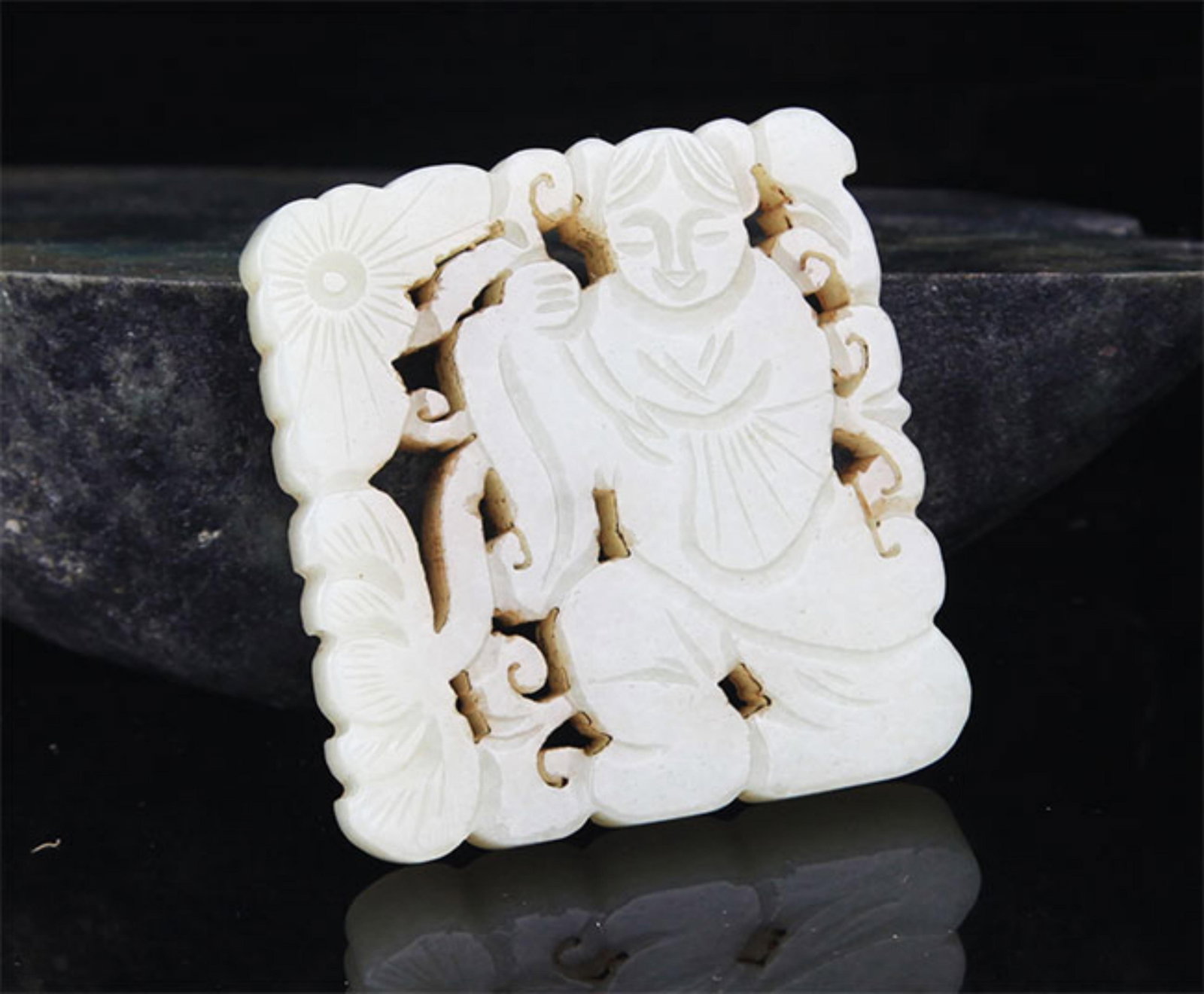 A FINE HE TIAN JADE IN FIGURE OF BOY WITH LOTUS: 20th Century; High: 2.25inch; Width: 1.8inch; . Wooden base for display only