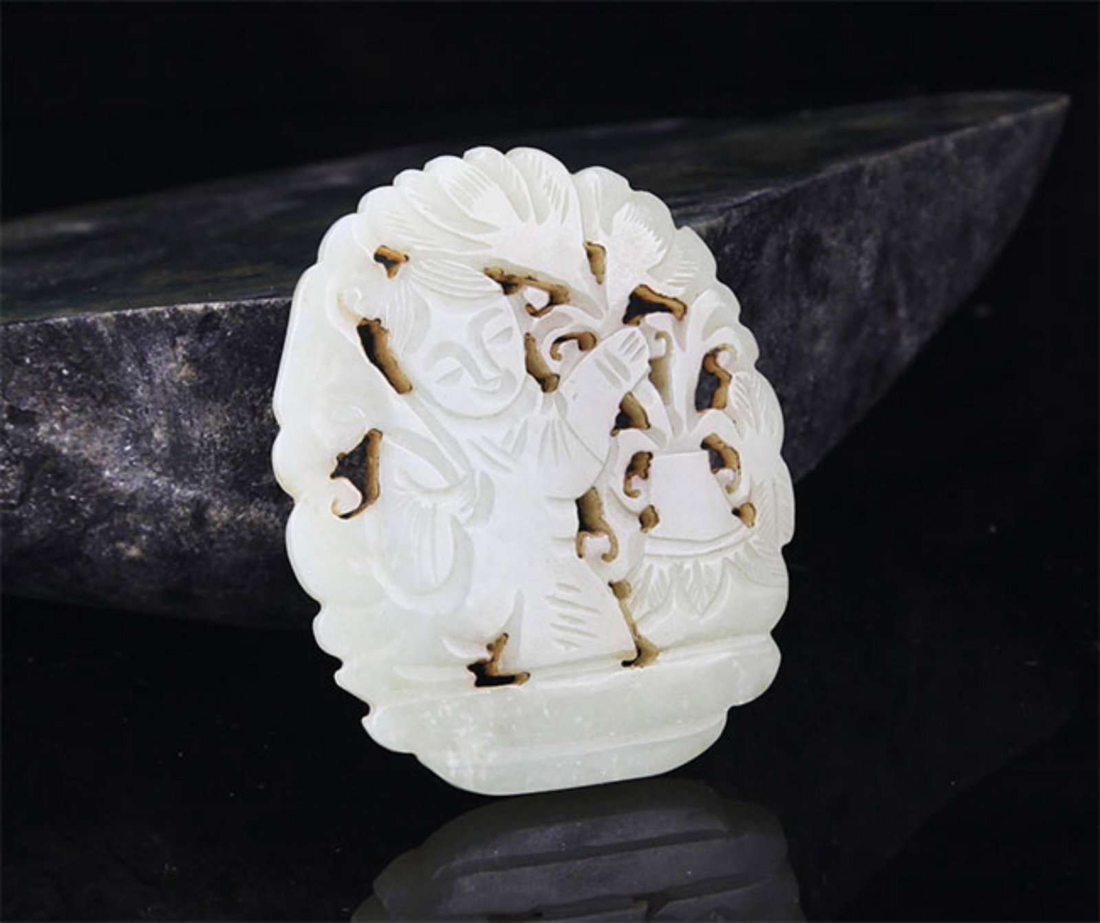A FINE HE TIAN JADE IN FIGURE OF BOY WITH LOTUS: 20th Century; High: 2.7 inch; Width: 1.98 inch; . Wooden base for display only