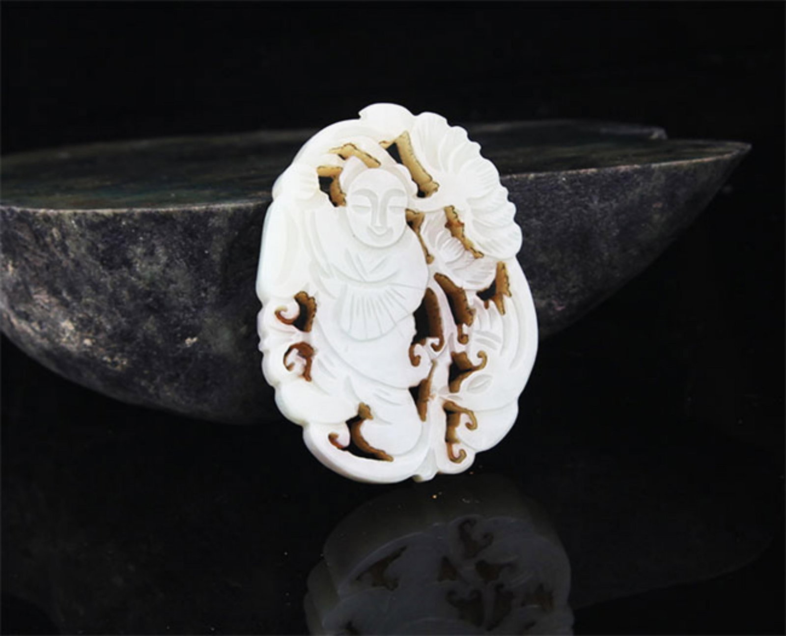 A FINE HE TIAN PALE CELADON JADE IN FIGURE OF BOY: 20th Century; High: 2.25 inch; Width: 1.6 inch; . Wooden base for display only