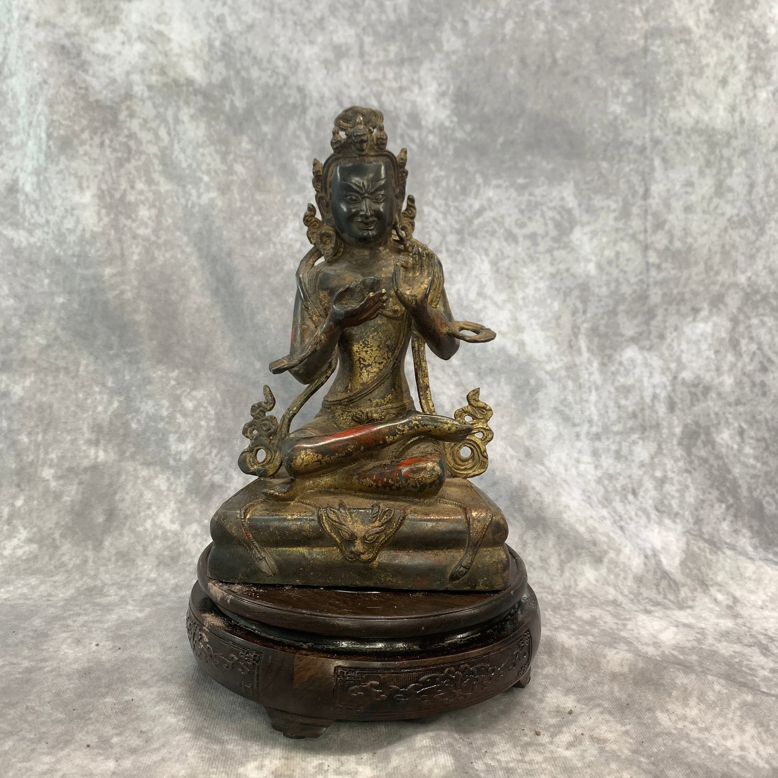 TIBETAN PARTIAL-GILT BRONZE STATUE OF A WRATHFUL DEITY: Qing Dynasty; Long: 5.3 inch; Width: 4.6 inch; High: 8.6 inch; . Wooden base for display only