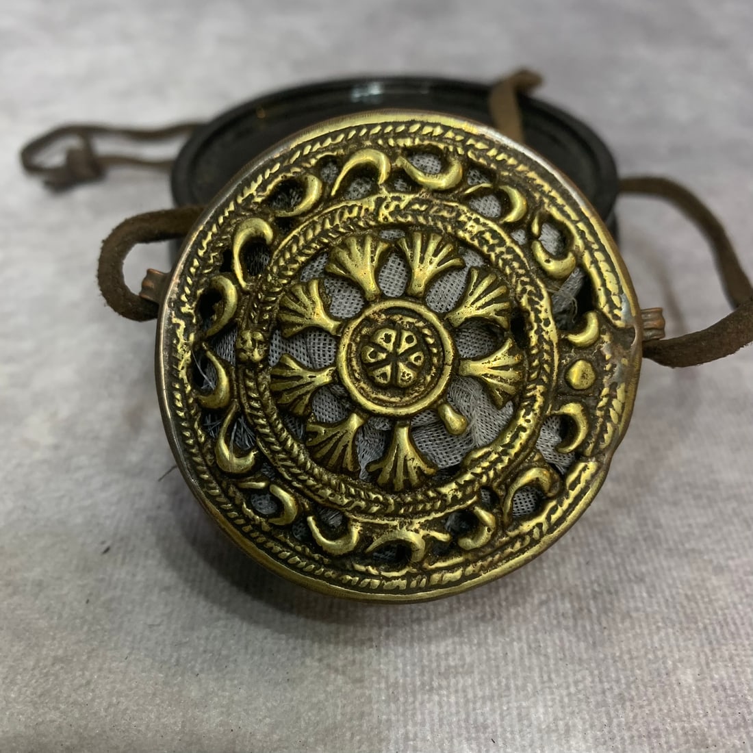 A FINE BRONZE TIBETAN BUDDHISM GAWU PENDANT: 20th Century; High: 1.0 inch; Diameter: 2.3 inch; . Wooden base for display only