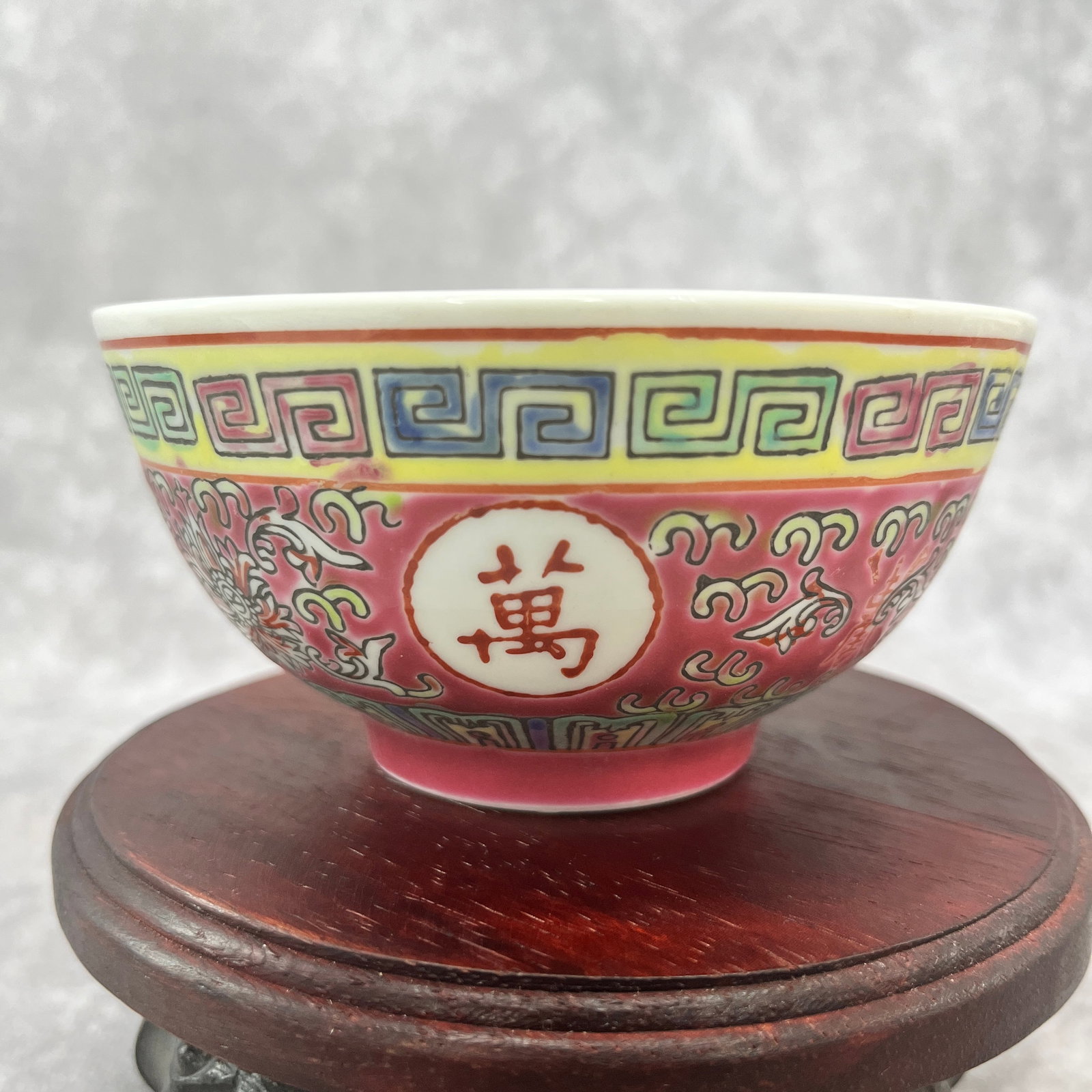 A FINE FAMILLE ROSE WAN SHOU MARK PORCELAIN BOWL: 19th Century; High: 2.3 inch; Diameter: 4.5 inch; . Wooden base for display only
