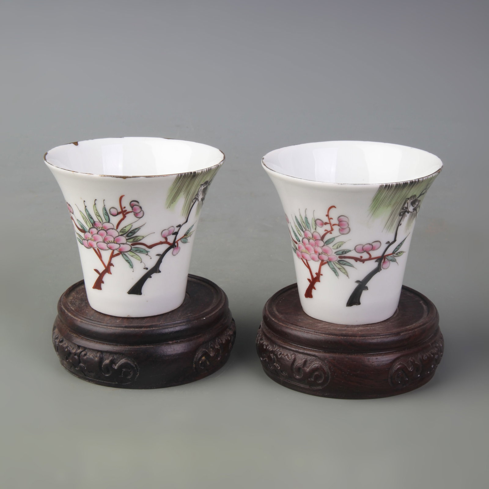 A PAIR OF FAMILLE ROSE TEACUPS WITH BIRD-AND-FLOWER DECORATION: Republic Period; Diameter: 2.9 inch; High: 2.5 inch; . Wooden base for display only