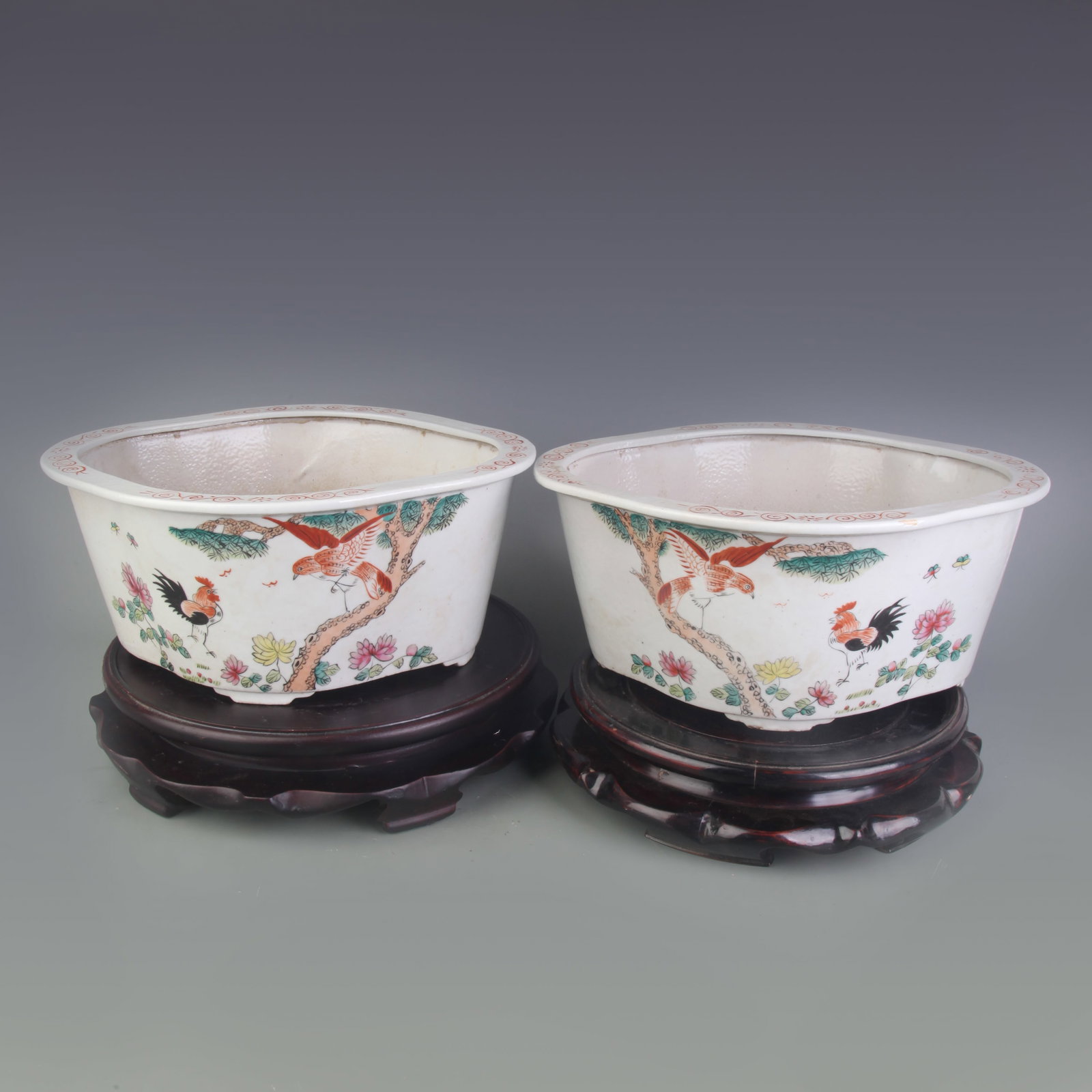 PAIR OF FAMILLE ROSE FLOWER AND BIRD DESIGN FLOWERPOTS: Republic Period; Long: 11.3 inch; High: 5.0 inch. Wooden base for display only