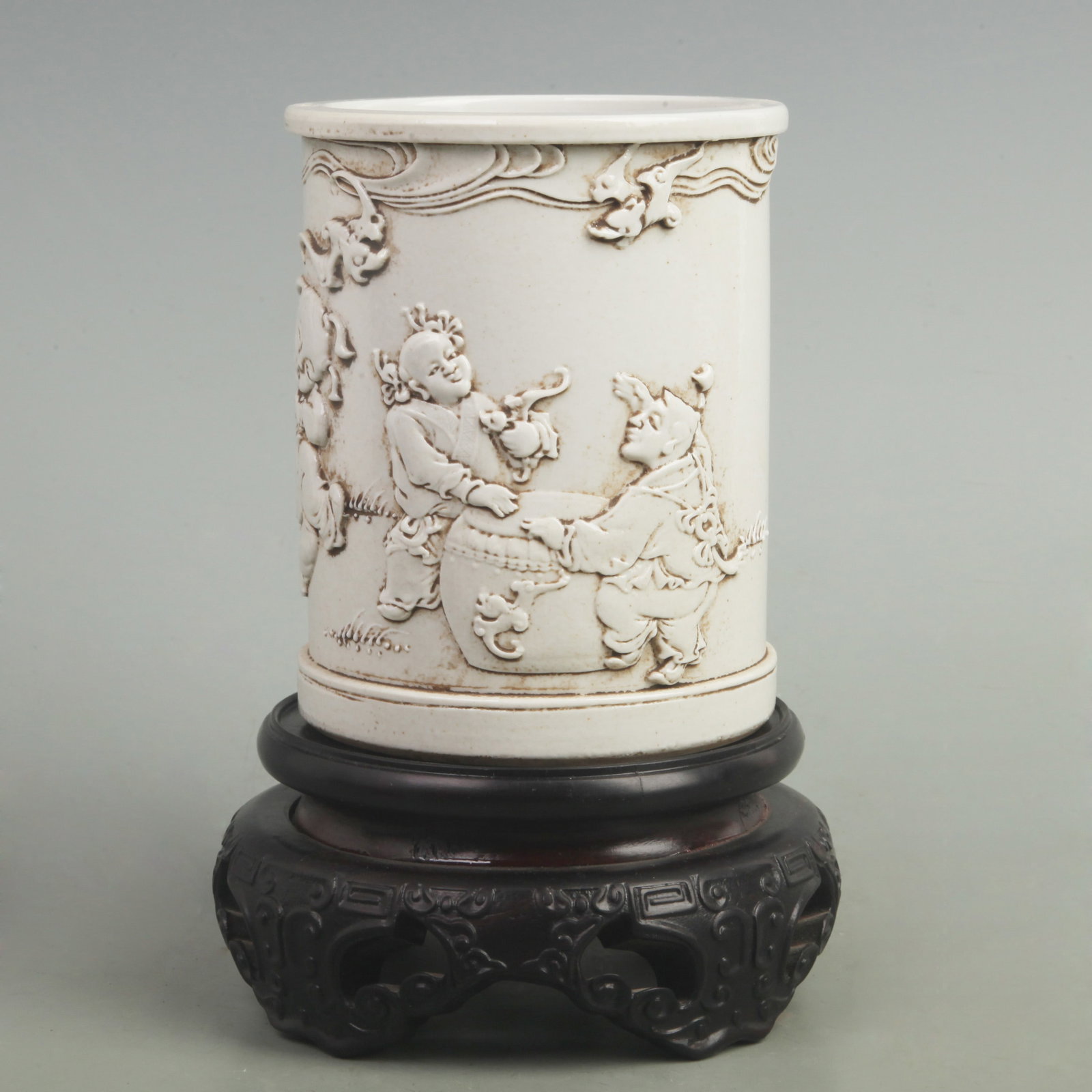 WANG BING RONG MARK "CHILD PLAYING DRUM" PORCELAIN BRUSH POT: Qing Dynasty; High: 5.5 inch; Diameter: 4.3 inch. Wooden base for display only
