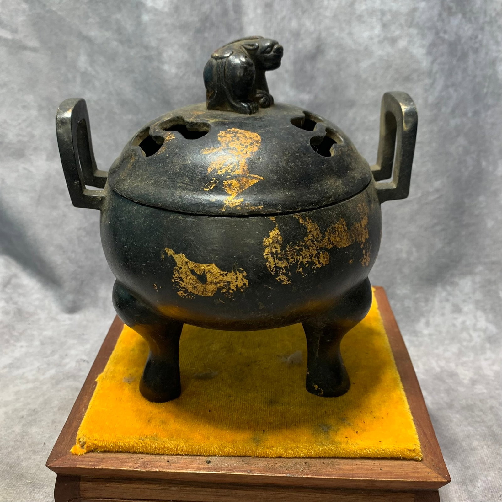 A MING-STYLE GILT-BRONZE TRIPOD CENSER WITH LION FINIAL AND UPRIGHT HANDLES, BEARING A PRIVATE MARK: Ming Dynasty Style; H; 6.4 inch; Diameter: 5.7 inch. Wooden base for display only