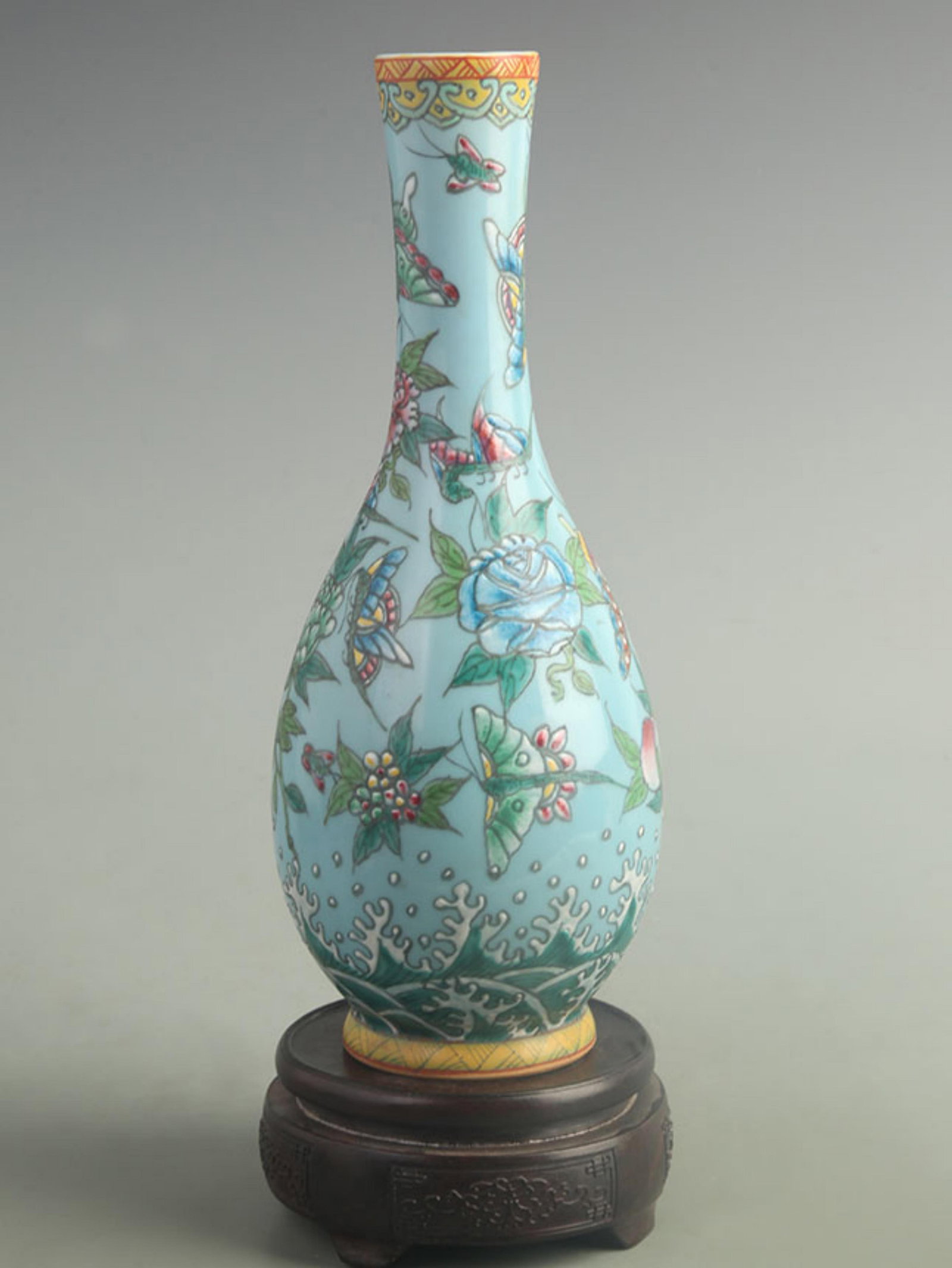 FAMILLE ROSE BLUE GROUND FLORAL LONG-NECK PORCELAIN VASE: Qing Dynasty Qian Long Period; High: 11.5 inch;Width: 4.20 inch;. Wooden base for display only