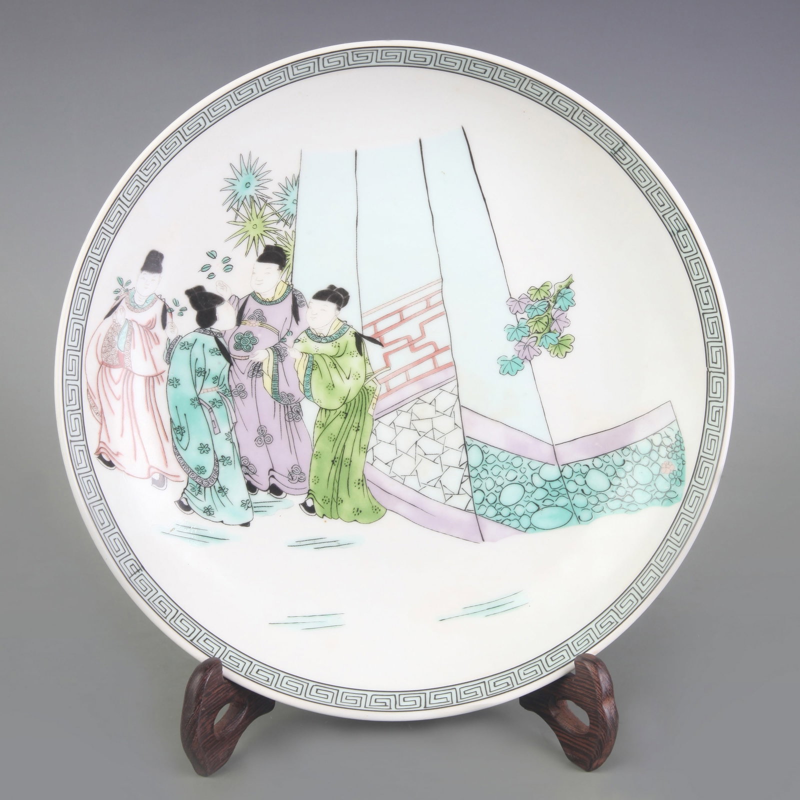 FAMILLE ROSE FIGURE PATTERN PLATE: Qing Dynasty Qian Long Period: Diameter: 8.8 inch; High: 1.7 inch. Wooden base for display only