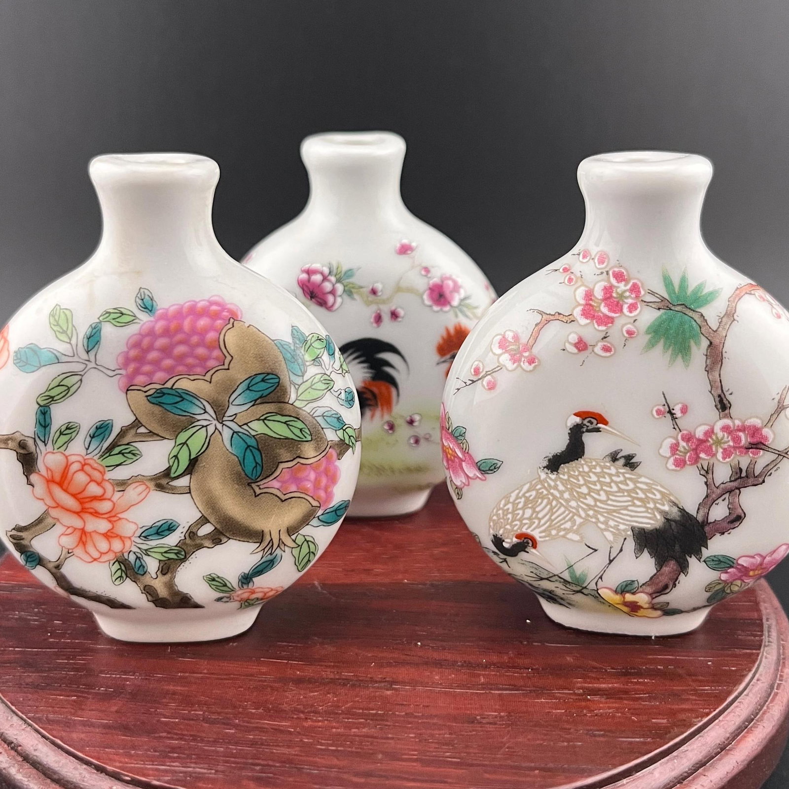 GROUP OF THREE FAMILLE ROSE SNUFF BOTTLES