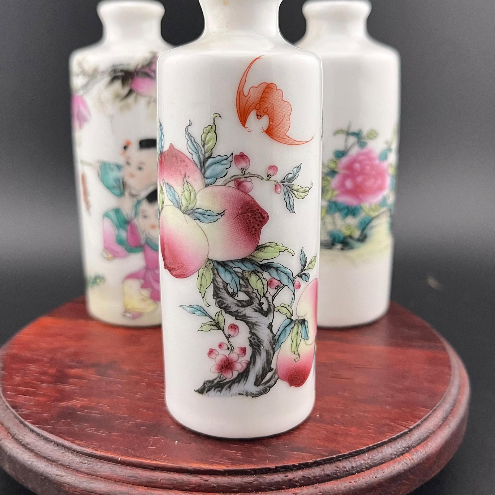 GROUP OF THREE FAMILLE ROSE SNUFF BOTTLES