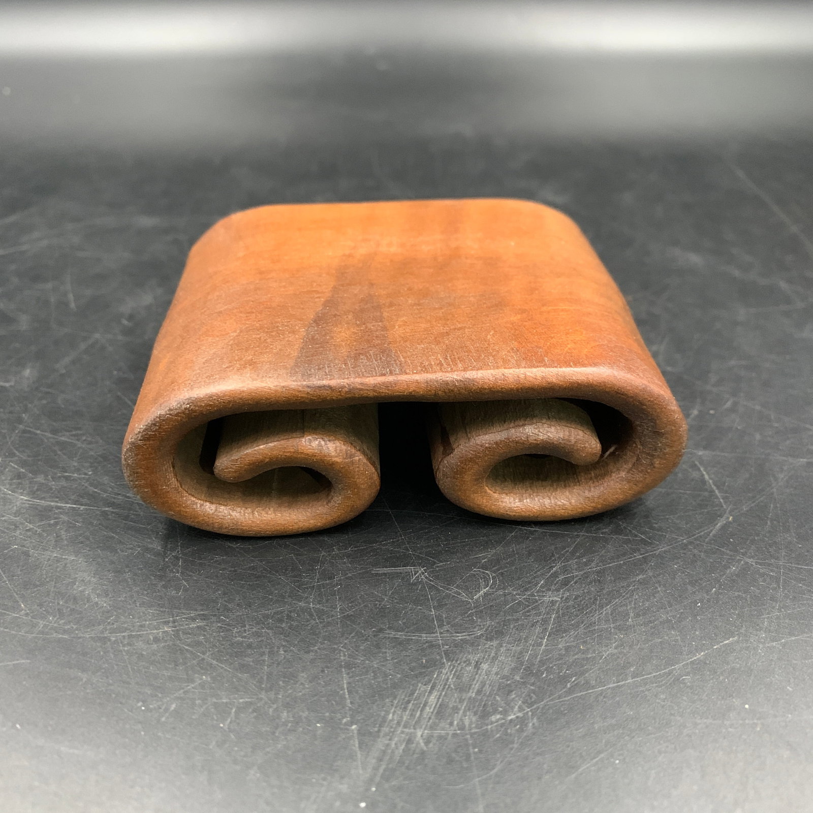 HAND-CARVED SCROLL-FORM WOODEN WRIST STAND