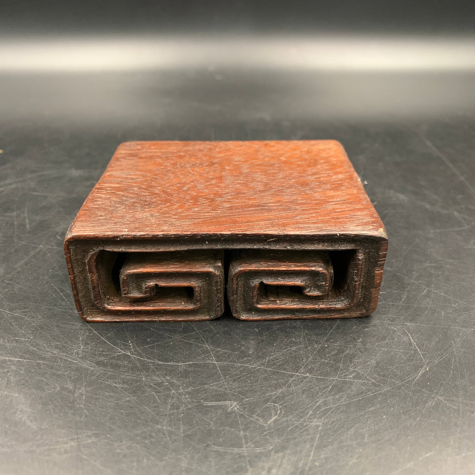 HAND-CARVED SCROLL-FORM WOODEN WRIST STAND