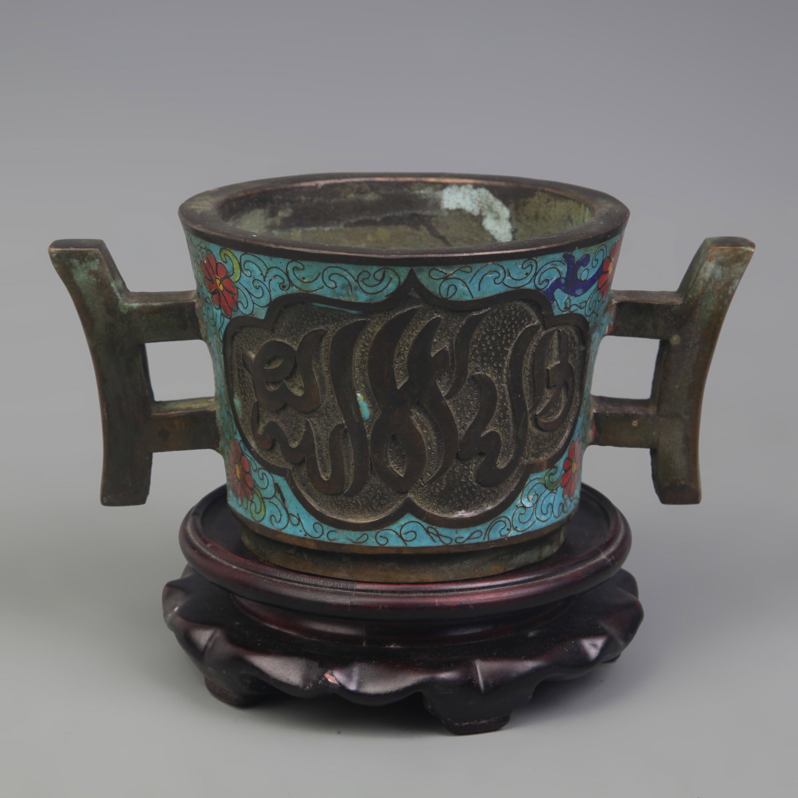 BRONZE RESERVE-PANEL DOUBLE-HANDLED ROUND-FOOTED INCENSE BURNER: Qing Dynasty Qian Long Period; Long: 7.4 in; W: 4.6 in; High: 3.5 in. Wooden base for display only