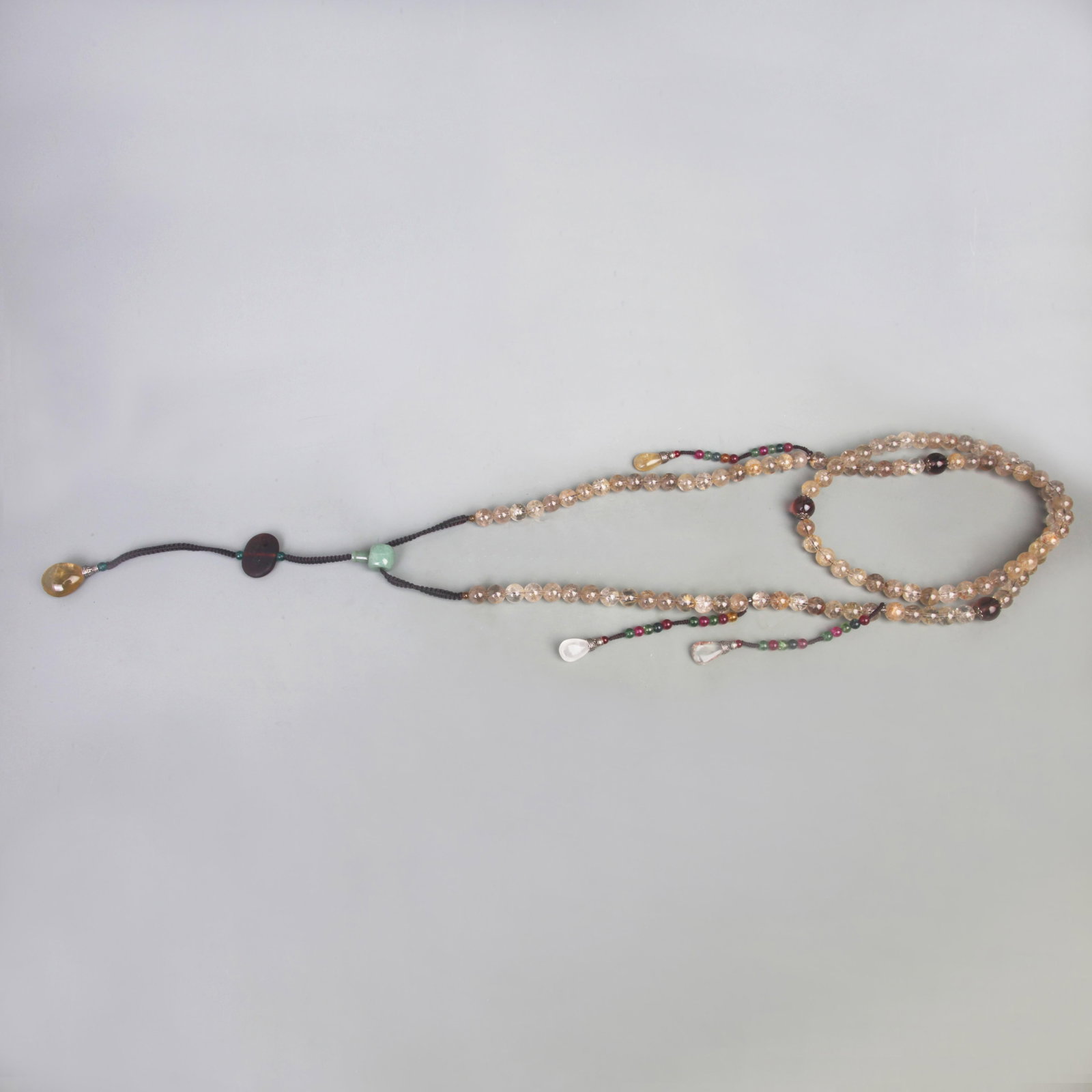 108-PIECE CRYSTAL PRAYER BEADS WITH NATURAL CRYSTAL, JADE, AND CRYSTAL: Qing Dynasty; Long: 84 inch; . Wooden base for display only