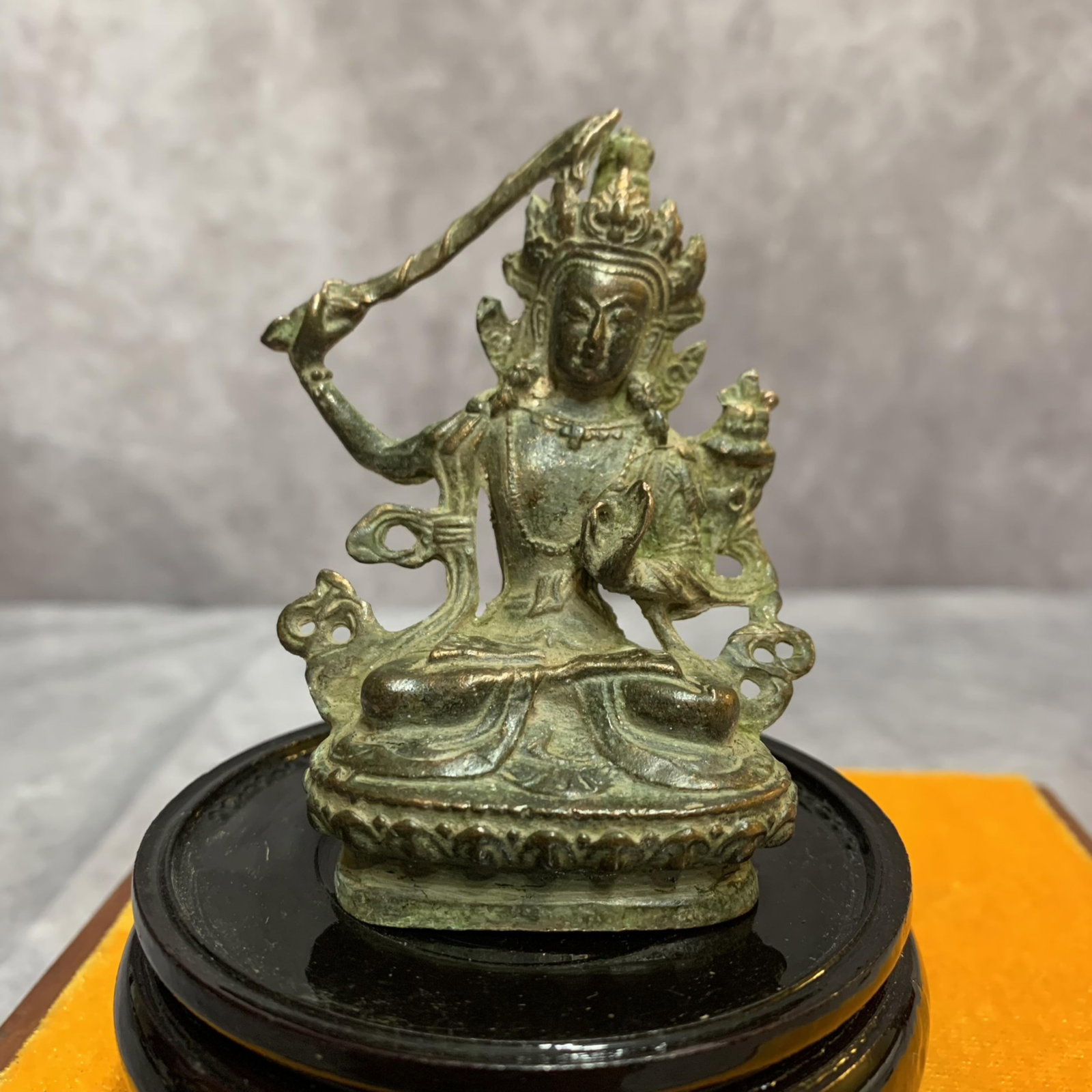 A FINE SMALL BRONZE MANJUSHRI BUDDHA STATUE: 19th Century; Width: 2.1 inch; High: 3.0 inch; Diameter: 1.1 inch; . Wooden base for display only