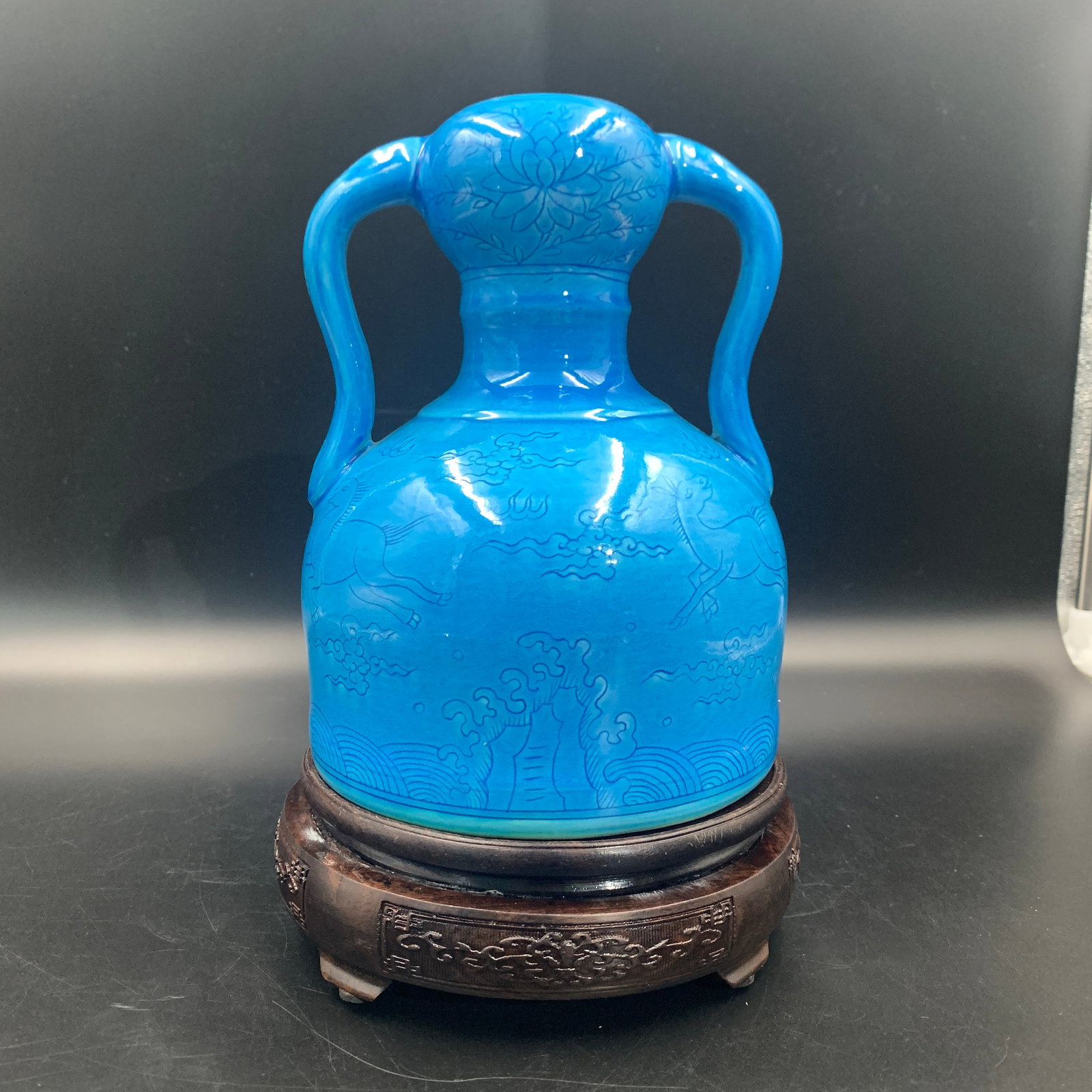 TURQUOISE COLOR GLAZED DRAGON-AND-HORSE PATTERN PORCELAIN FLASK: Ming Dynasty Style; High: 7.9 inch; Diameter: 5.8 inch; . Wooden base for display only