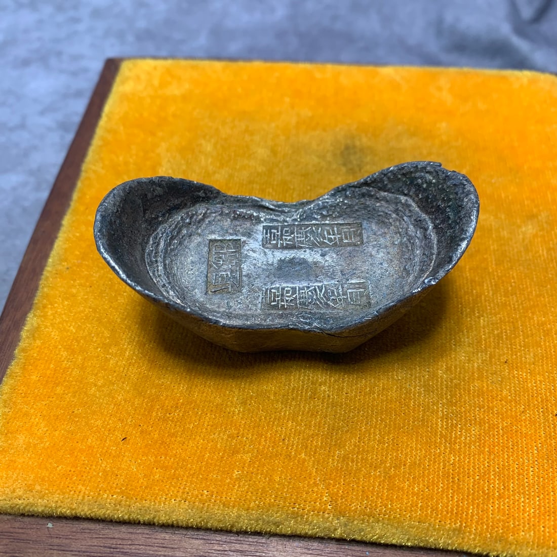 A COPY OF CHINESE SILVER SYCEE YUANBAO: Qing Dynasty Style; Long: 2.9 inch; Width: 1.5 inch; H; 1.2 inch. . Wooden base for display only
