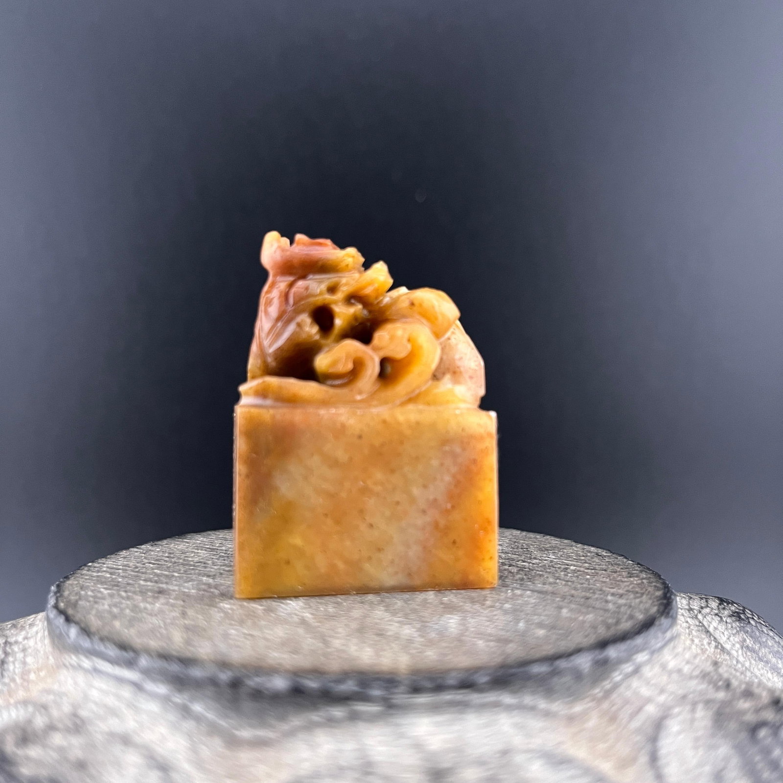 A SMALL CARVED SHOUSHAN STONE SEAL: Modern; Long: 1.1 inch; Width: 0.6 inch; High: 1.6 inch; . Wooden base for display only