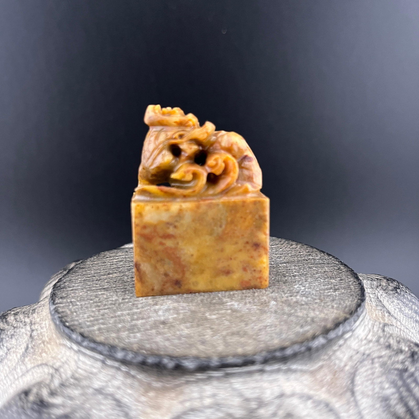 A SMALL CARVED SHOUSHAN STONE SEAL: Modern; Long: 1.1 inch; Width: 0.6 inch; High: 1.6 inch; . Wooden base for display only
