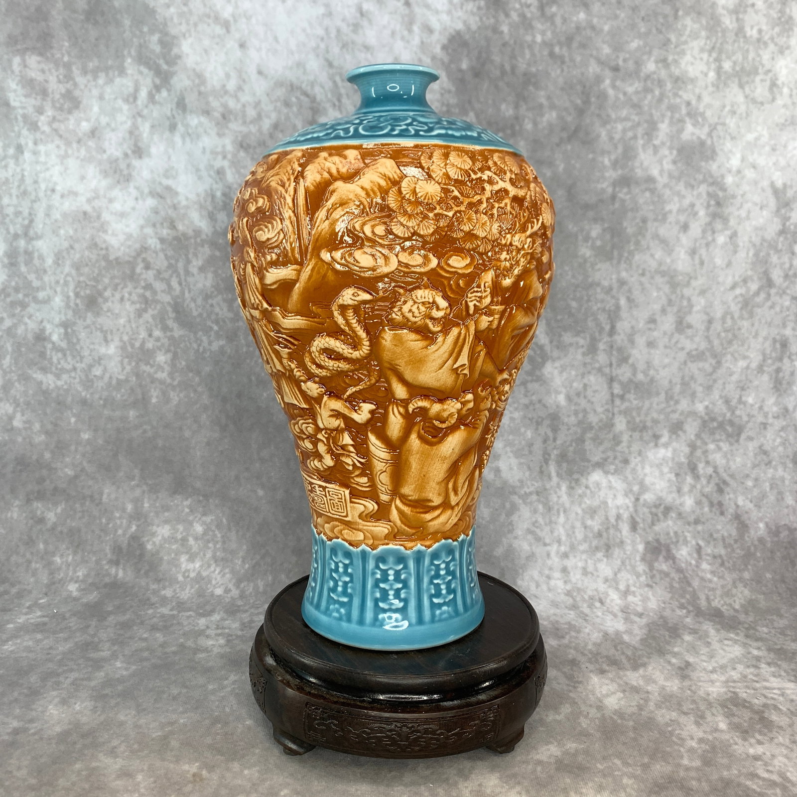 RELIEF-CARVED TRI-COLOR "EIGHTEEN LUOHANS" MEIPING VASE: Ming Dynasty Style; High: 11.6 inch; Diameter: 6.8 inch; . Wooden base for display only