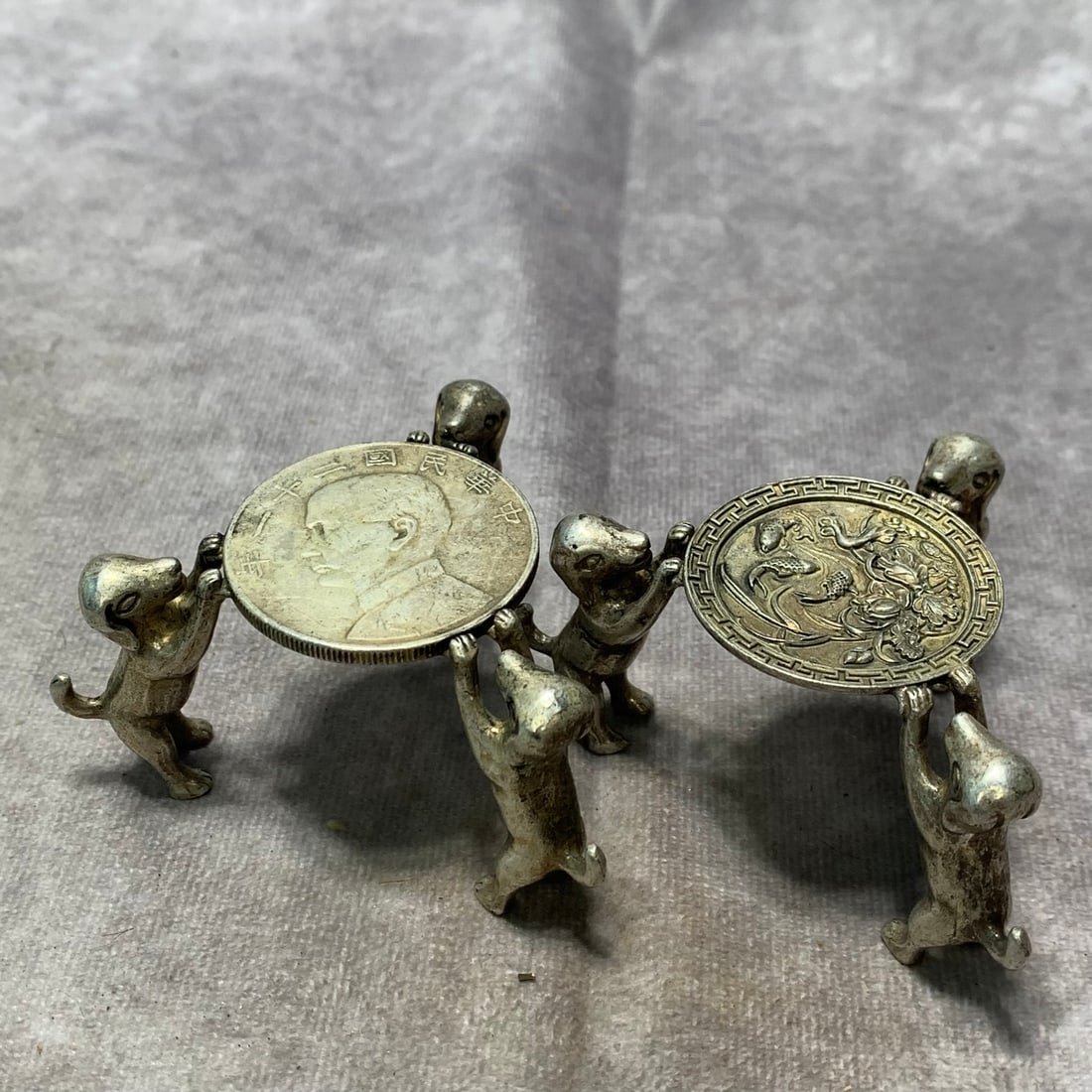 PAIR OF WHITE BRONZE TEA CUP BEDS WITH THREE DOG LEGS: Republic Period; Long: 3.1 inch; High: 1.6 inch; . Wooden base for display only