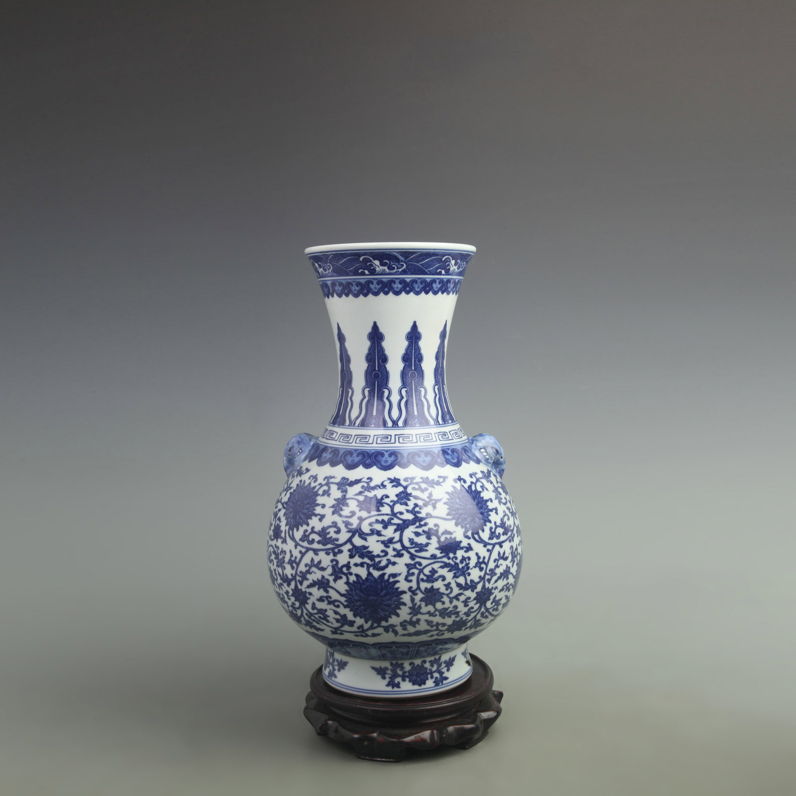 BLUE AND WHITE FLOWER PATTERN PORCELAIN VASE: Qing Dynasty Qian Long Period; High: 15 inch; Diameter: 5.7 inch; . Wooden base for display only