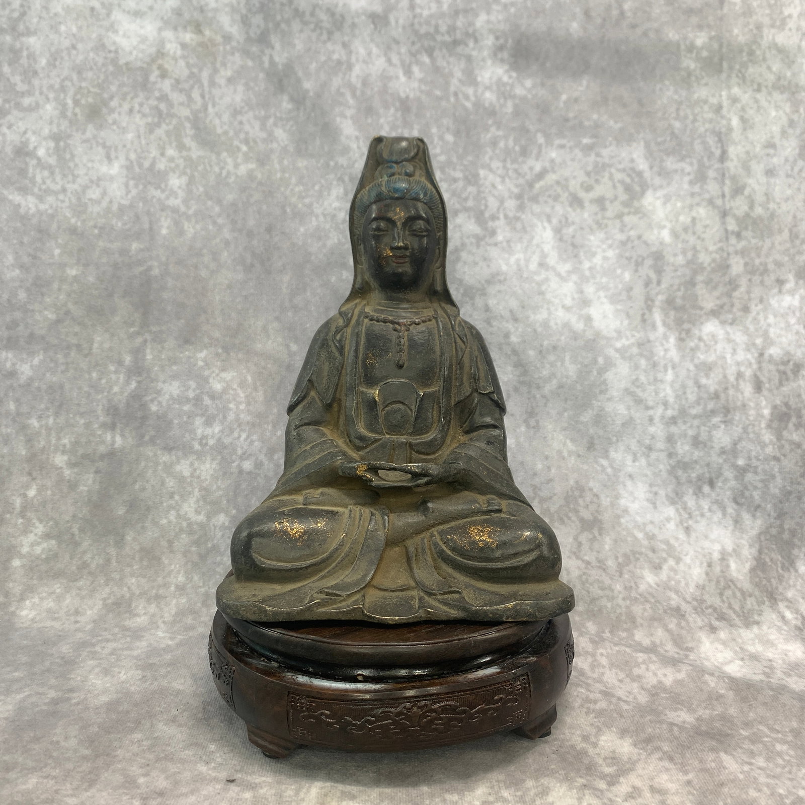 GILT AND LACQUERED BRONZE SEATED GUANYIN: Qing Dynasty; Long: 6 inch; Width: 5.3 inch; High: 8.3 inch; . Wooden base for display only