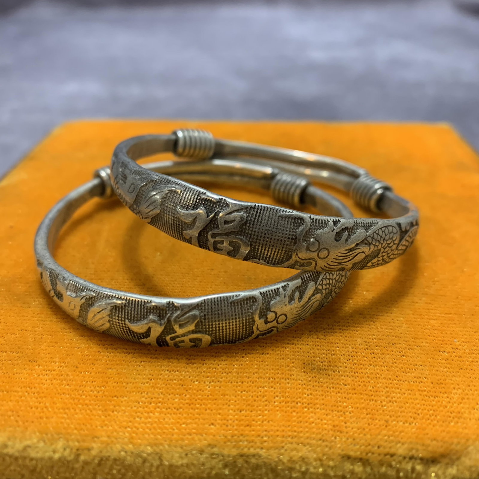 PAIR OF WHITE BRONZE BANGLE: Modern; Diameter: 2.6 inch; . Wooden base for display only