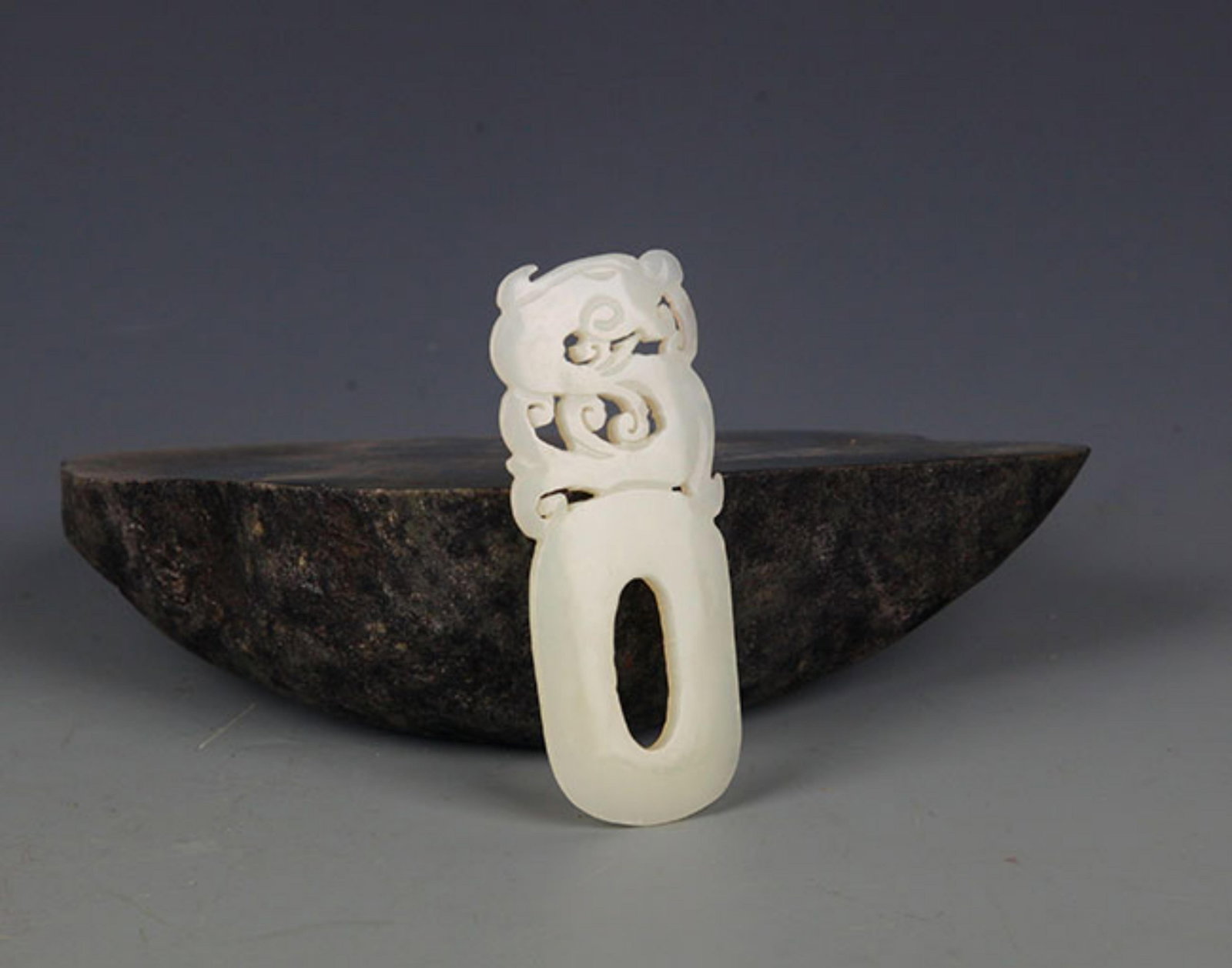 A FINE PALE CELADON JADE PENDANT IN FIGURE OF DRAGON: Modern; High: 3.5 inch; Width: 1.0 inch; . Wooden base for display only