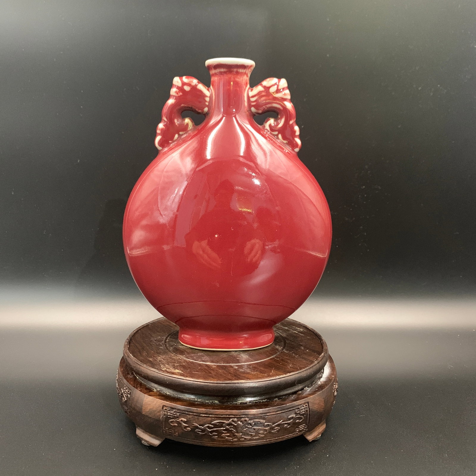 OXBLOOD (SANG-DE-BOEUF) PORCELAIN MOON FLASK: Ming Dynasty Style; Long: 6.1 inch; Width: 3 inch; High: 8 inch; . Wooden base for display only