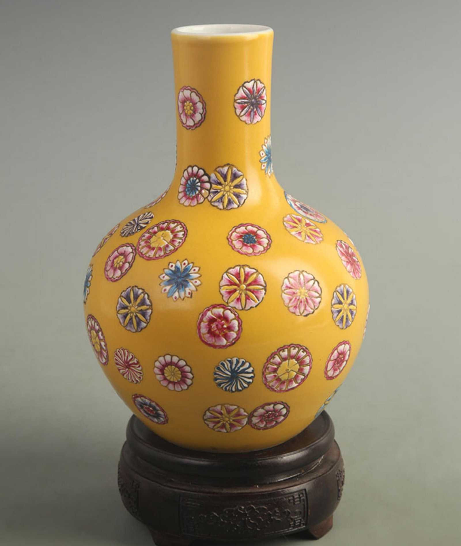 FAMILLE ROSE YELLOW GROUND FLORAL CELESTIAL SPHERE VASE: Qing Dynasty Qian Long Period; High: 8.20 inch; Width: 5.50 inch; . Wooden base for display only