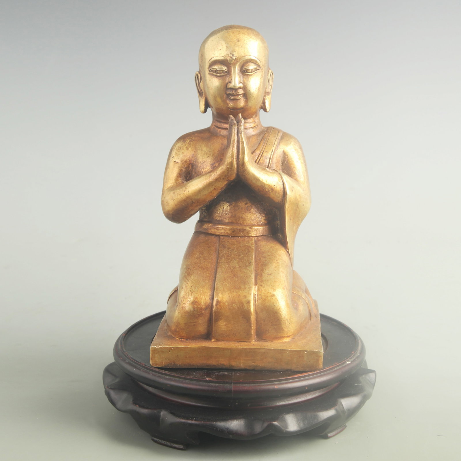 GILT-BRONZE KNEELING BUDDHA STATUE: 19th Century; High: 8.70 inch; Width: 4.20 inch. Wooden base for display only