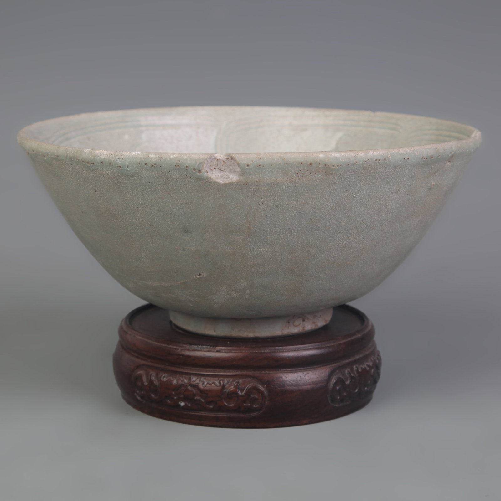 A FINE CELADON PORCELAIN PORCELAIN BOWL: Yuan Dynasty Style; Diameter: 6.3 inch; High: 2.8 inch. Wooden base for display only