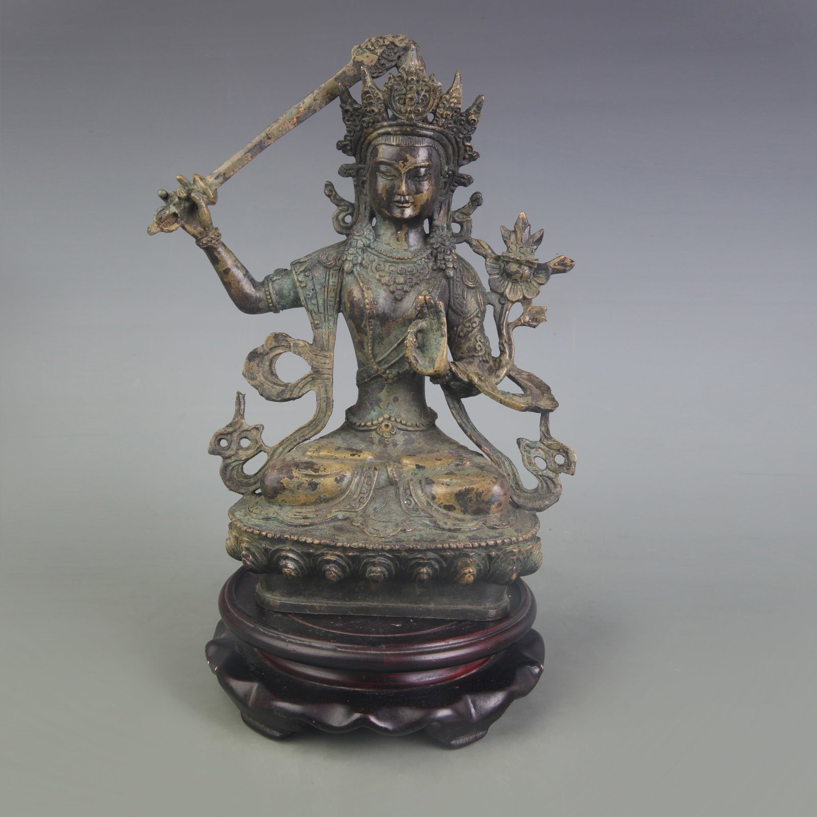 A FINE BRONZE MANJUSHRI BODHISATTVA FIGURE: Qing Dynasty; High: 8.3 inch. Wooden base for display only