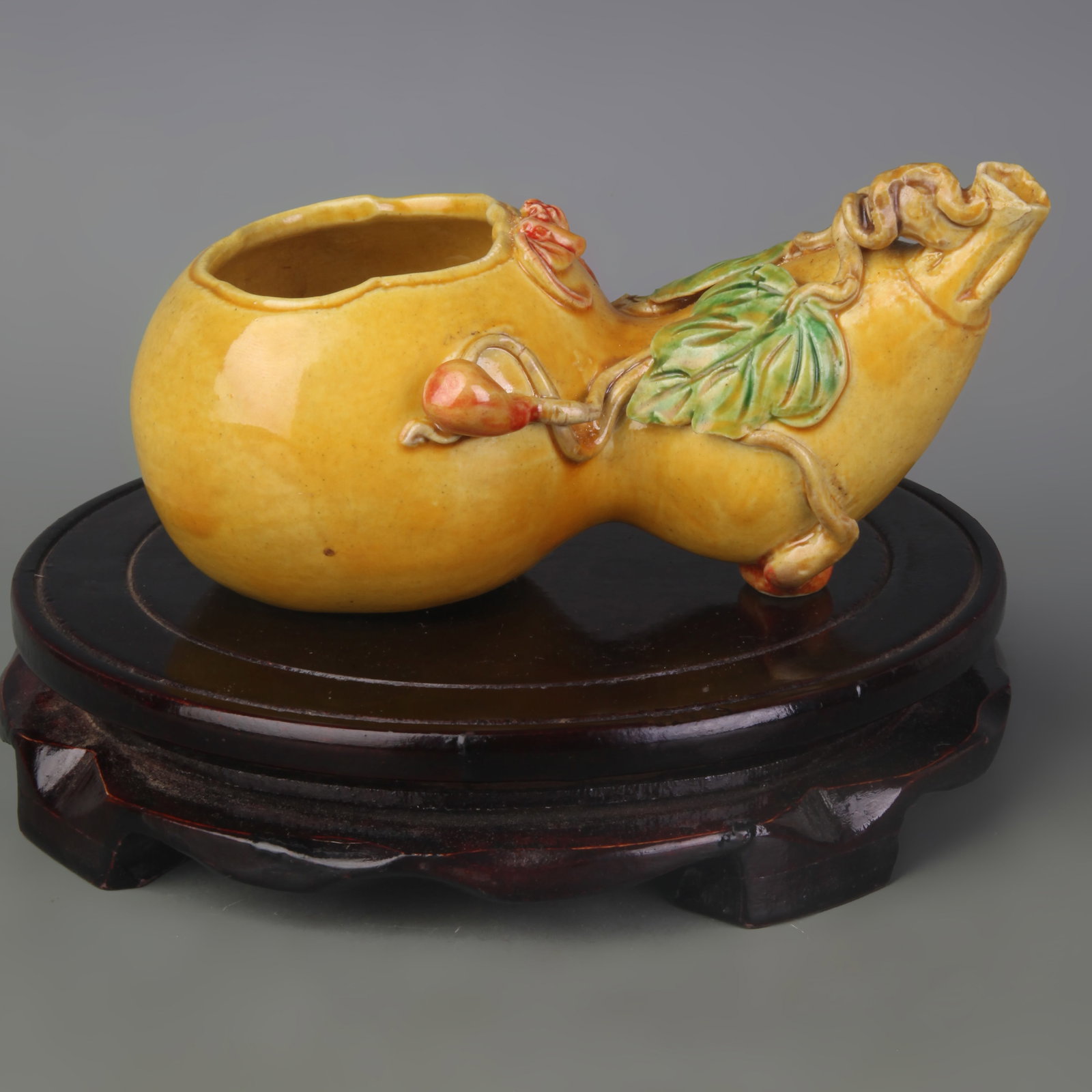 YELLOW-GLAZED WASHER WITH CARVED LONGEVITY MOTIFS: Qing Dynasty Qian Long Period; Width: 6.2inch ; High: 2.7inch; . Wooden base for display only