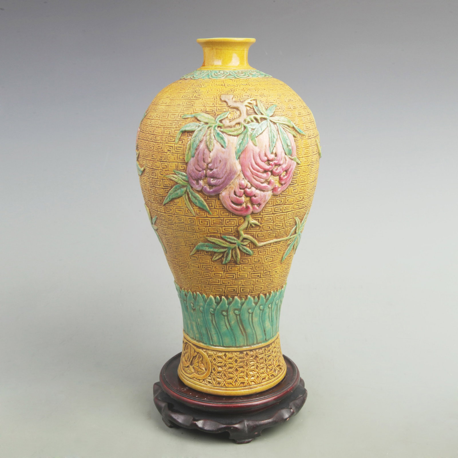 A YELLOW GOUND PEACH AND POMEGRANATE PATTERN VASE: Qing Dynasty Qian Long Period; High: 15.5 inch; Width: 8 inch; . Wooden base for display only