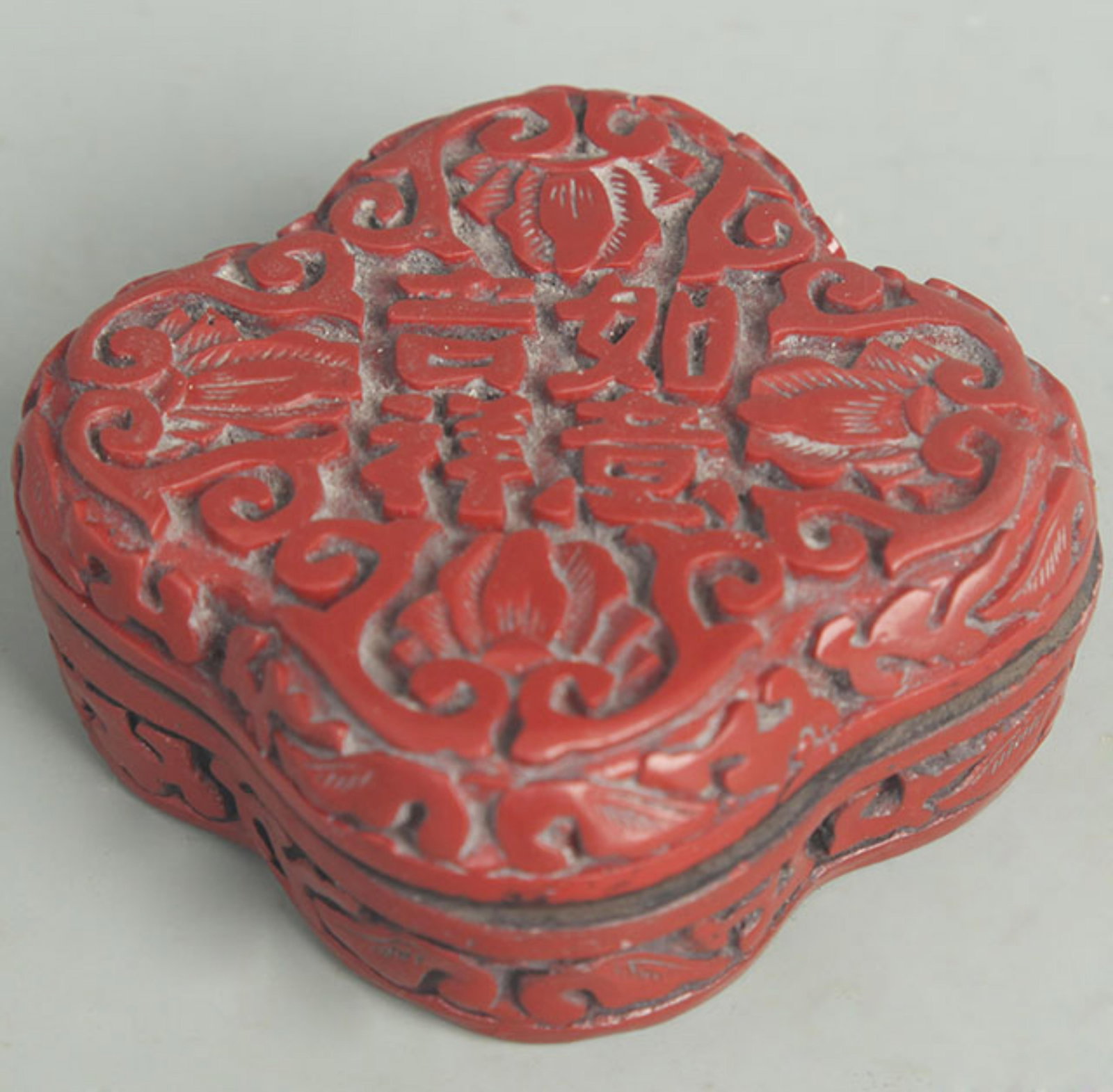 CARVED RED LACQUER EIGHT TREASURES PATTERN INCENSE BOX: Qing Dynasty; High: 1.00 inch Width: 2.50 inch . Wooden base for display only