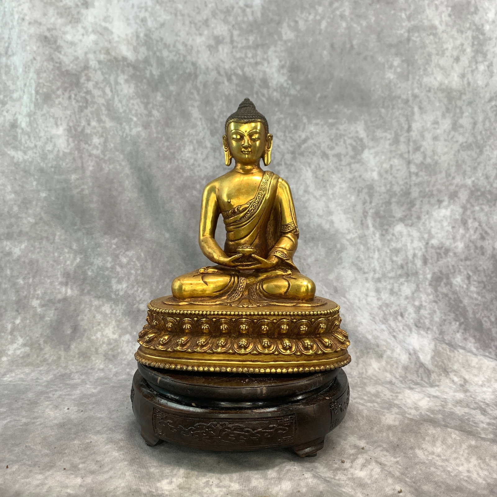 TIBETAN GILT BRONZE STATUE OF THE MEDICINE BUDDHA: Qing Dynasty; Long: 6.6 inch; Width: 4.4 inch; High: 8 inch; . Wooden base for display only