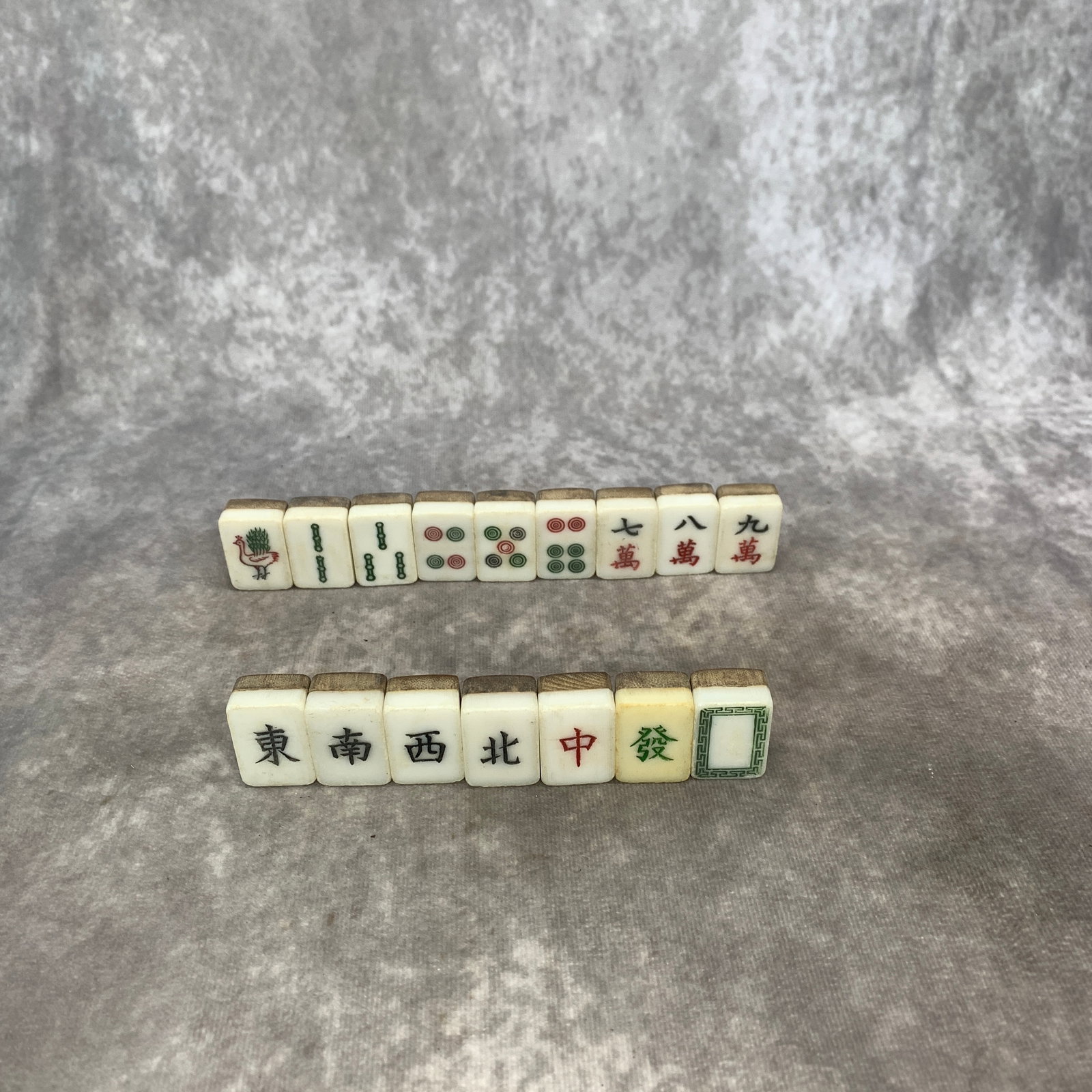 VINTAGE CHINESE BOVINE BONE AND BAMBOO MAHJONG: Republic Period; Long: 1.1 inch; Width: 0.78 inch; High: 0.5 inch; . Wooden base for display only