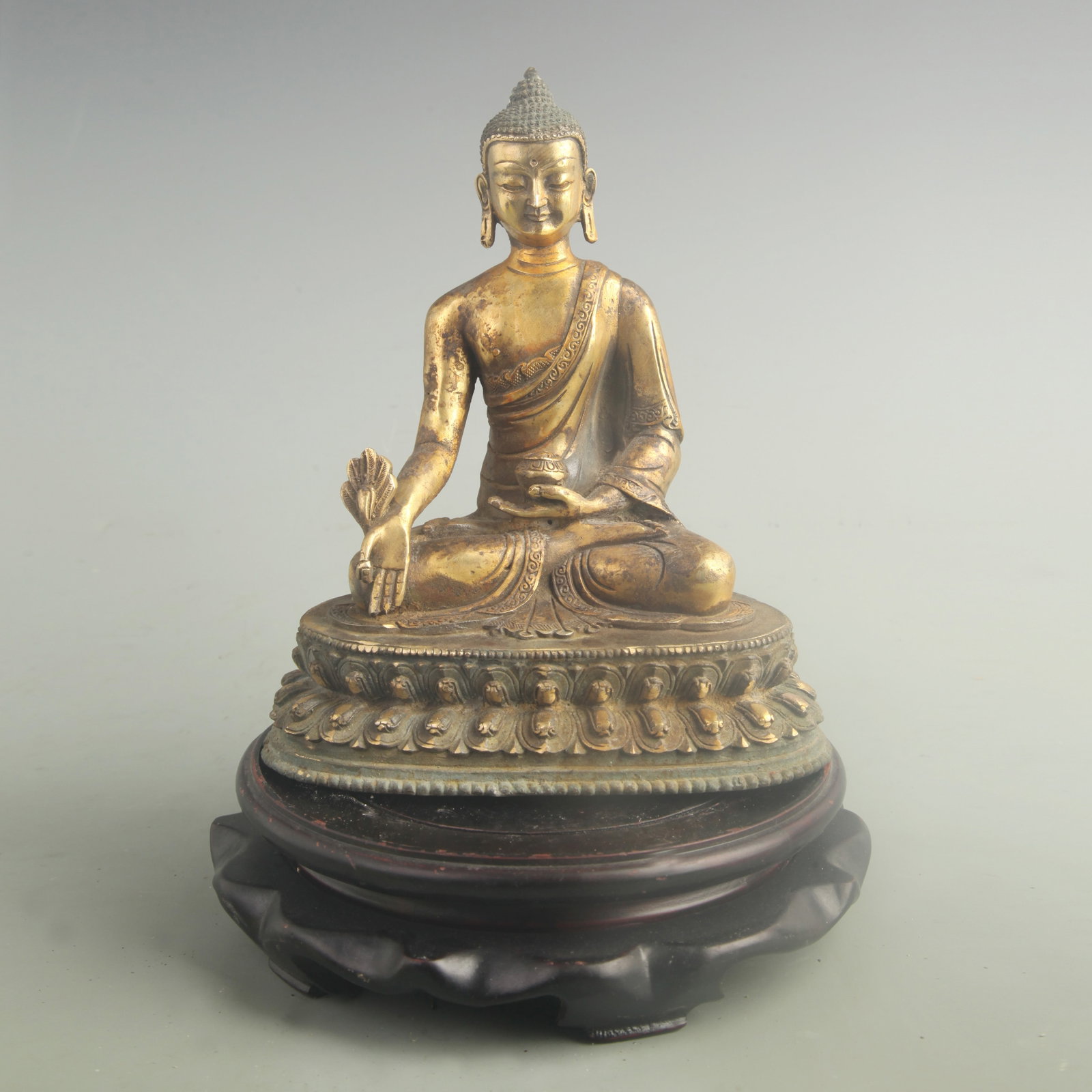 A GILT BRONZE THREE JEWELS BUDDHA FIGURE