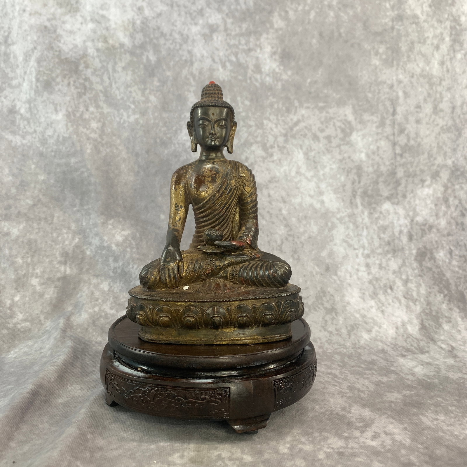 TIBETAN PARTIAL-GILT BRONZE FIGURE OF SHAKYAMUNI BUDDHA: Qing Dynasty; Long: 5.2 inch; Width: 3.4 inch; High: 7.6 inch; . Wooden base for display only