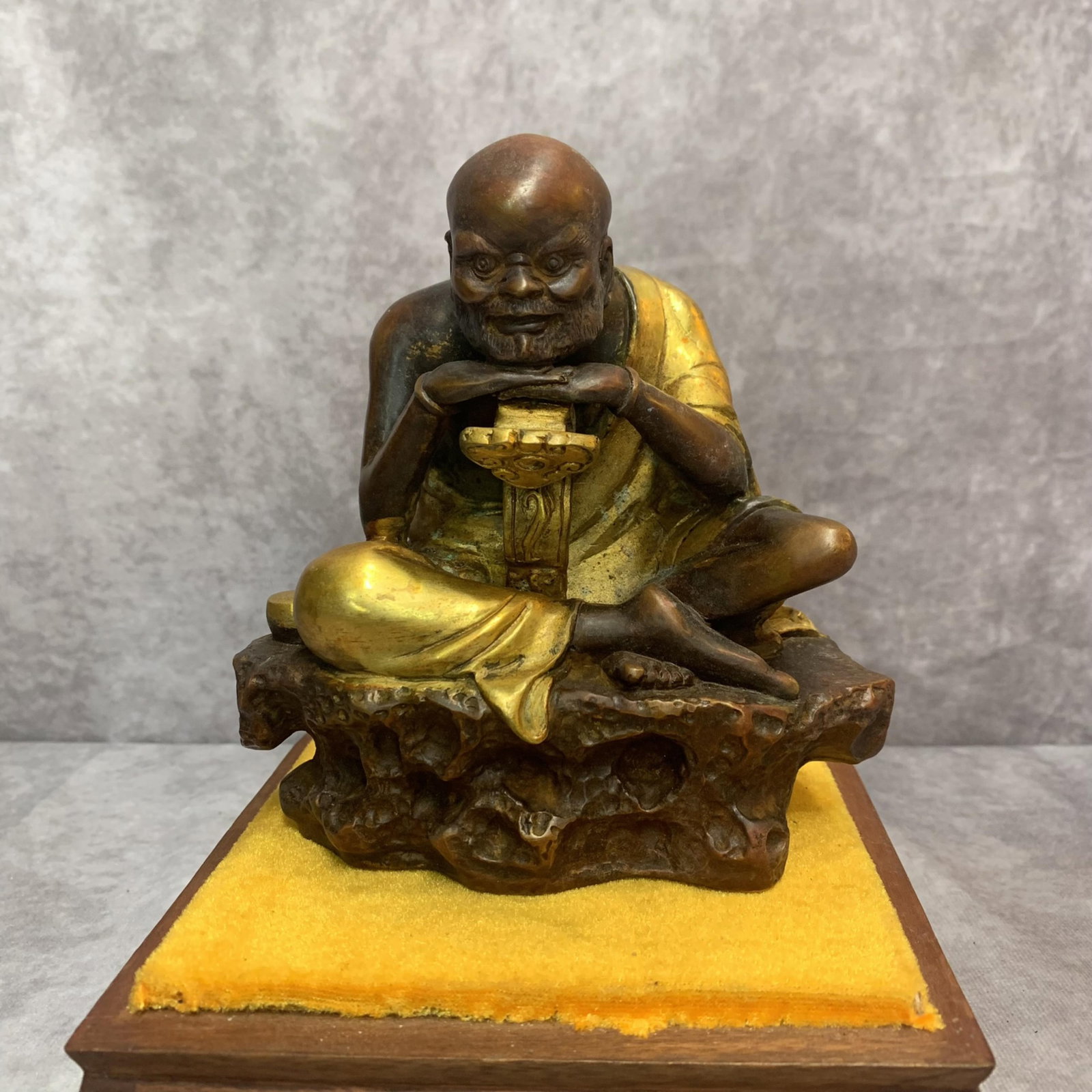 A FINE BRONZE LU HAN STATUE: 20th Century; High: 6.3 inch; Width: 5.6 inch; Long: 3.2 inch. Wooden base for display only