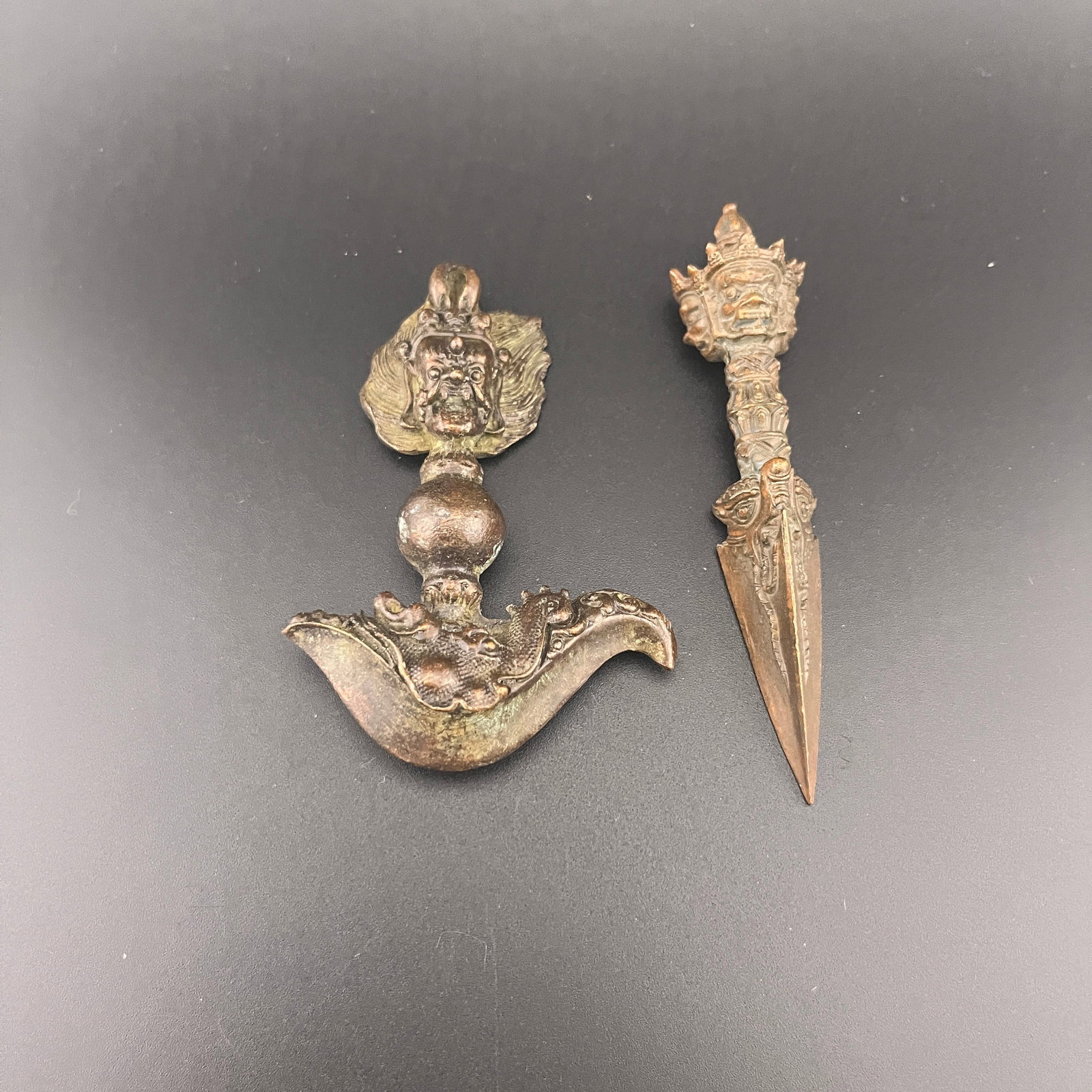 TIBETAN RITUAL BRONZE KARTIKA (FLAYING KNIFE) & PHURBA (DAGGER) PAIR: Qing Dynasty; High: 3.8 inch; Diameter: 0.8 inch; Long: 2.25 inch; Width: 0.6 inch; High: 3.2 inch; . Wooden base for display only