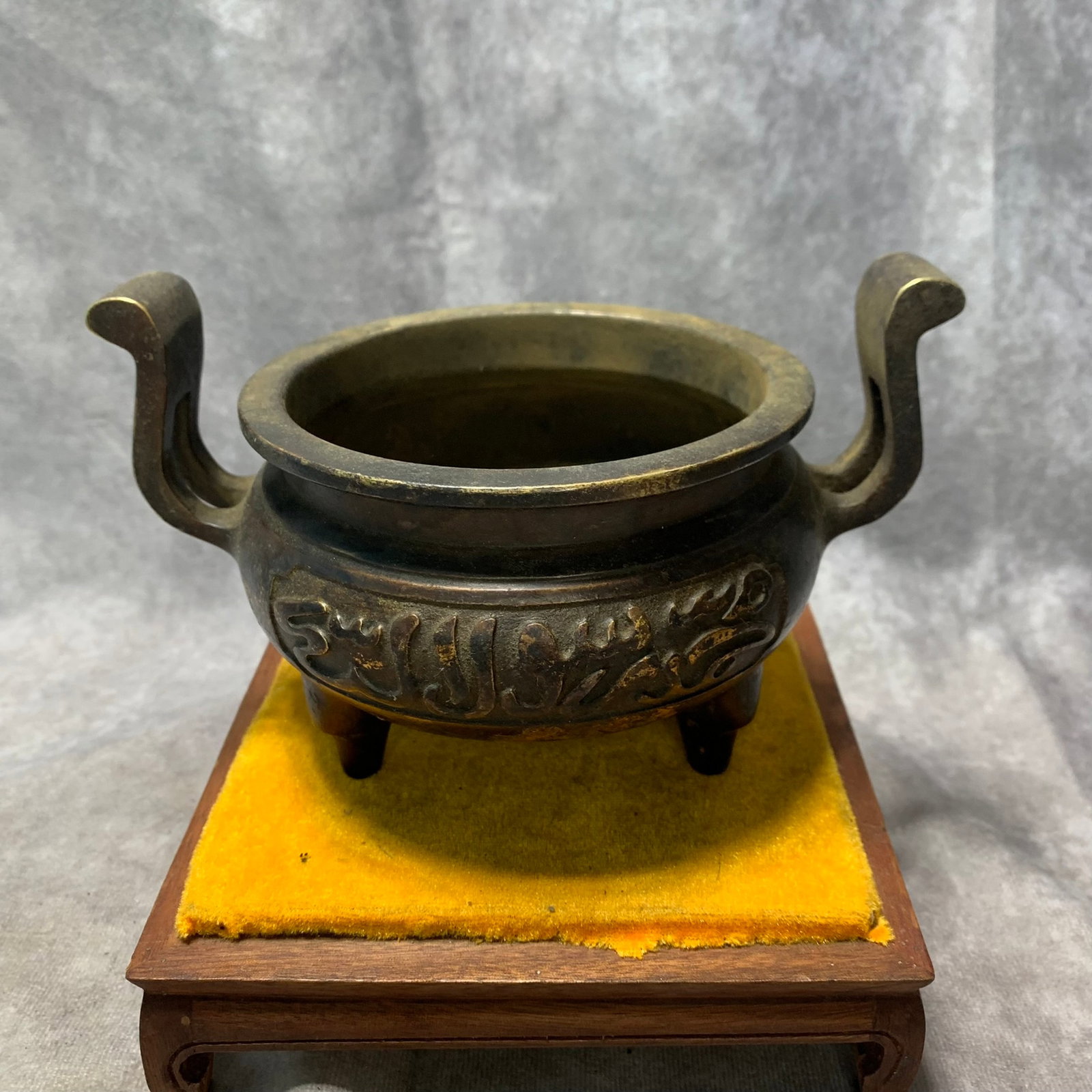 GILT BRONZE TRIPOD INCENSE BURNER WITH ARCHAIC EARS, XUANDE MARK: Ming Dynasty Style; High: 4.6 inch; Diameter: 7.3 inch; . Wooden base for display only
