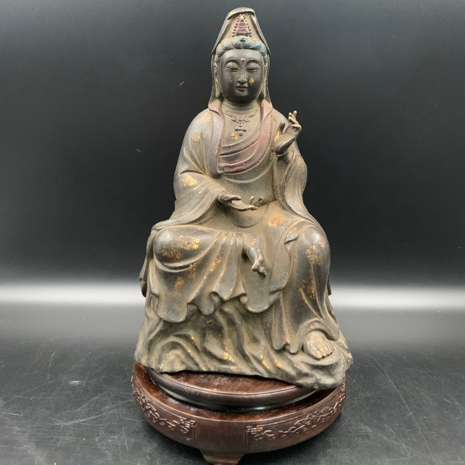 GILT BRONZE SEATED GUANYIN ON ROCKWORK: Qing Dynasty; Long: 6.2 inch; Width: 4.6 inch; High: 9.9 inch; . Wooden base for display only