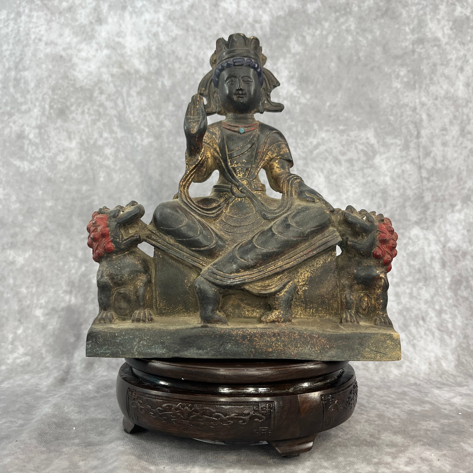GILT-LACQUERED BRONZE OR IRON STATUE OF MANJUSHRI: Qing Dynasty; Long: 7.6 inch; Width: 3.9 inch; High: 9 inch; . Wooden base for display only