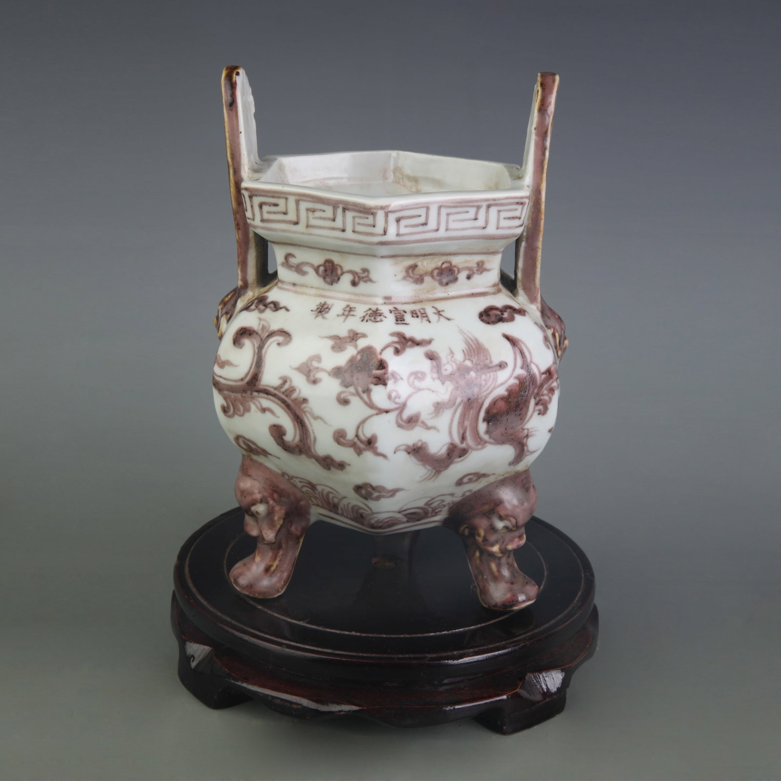 AN UNDERGLAZE RED AUSPICIOUS BEAST TRIPOD CENSER: Ming Dynasty Xuan De Style; Width: 5.2 inch; High: 7.9 inch. Wooden base for display only