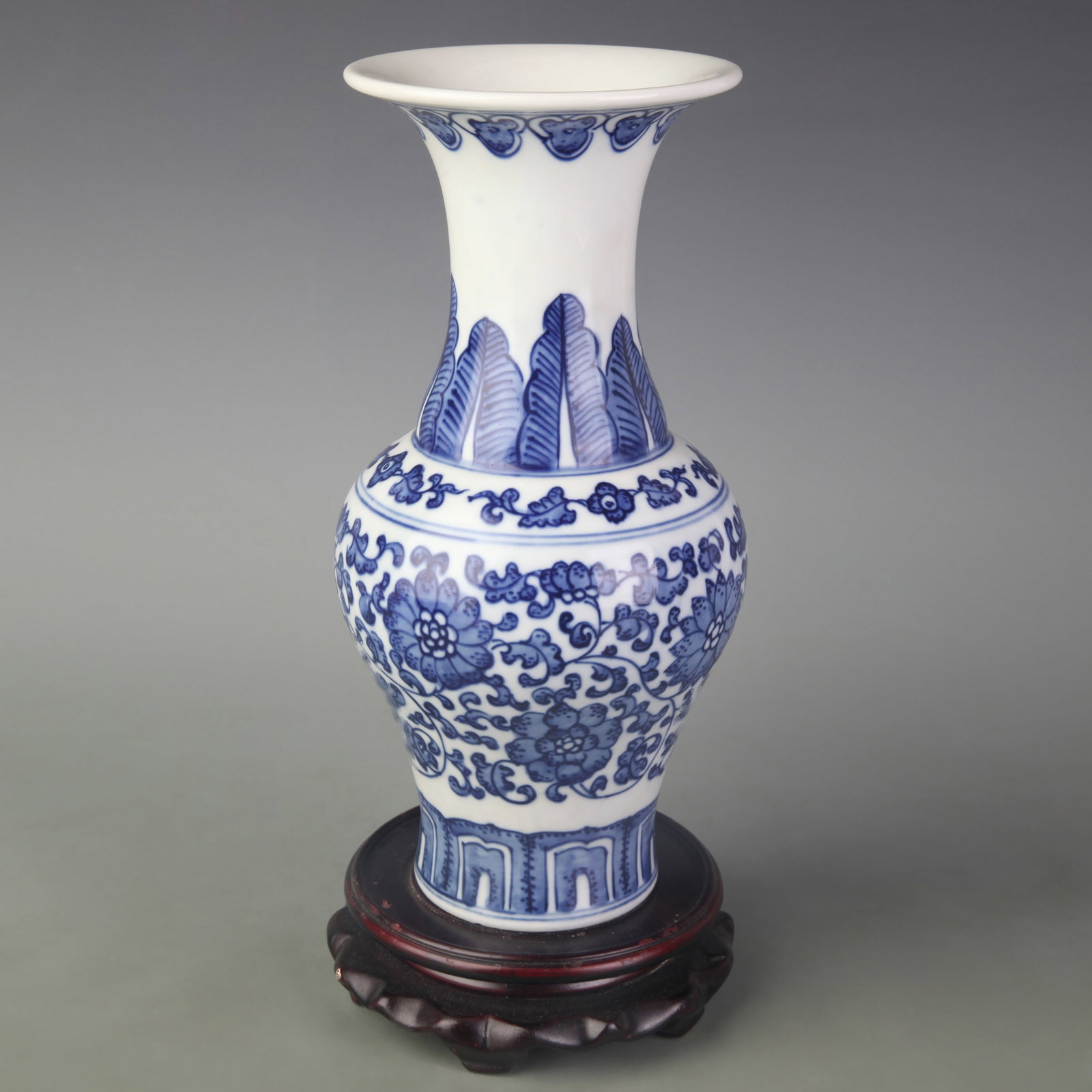 A BLUE AND WHITE PORCELAIN VASE WITH FLORAL DECORATION: Qing Dynasty Qian Long Period; Diameter: 4.4 inch; High: 10.0 inch; Wooden base for diplay only