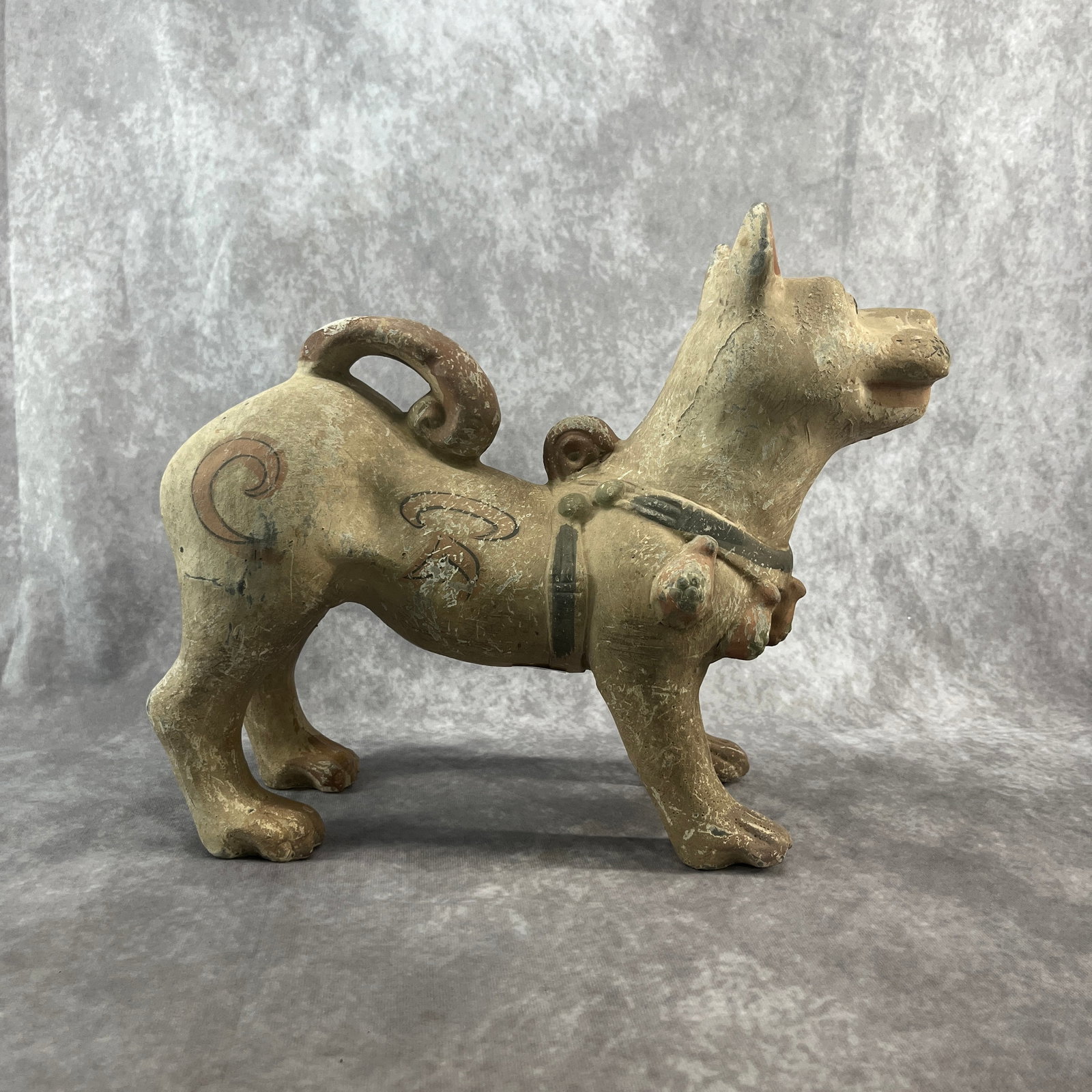 A FINE PAINTED POTTERY FIGURE OF A STANDING DOG
